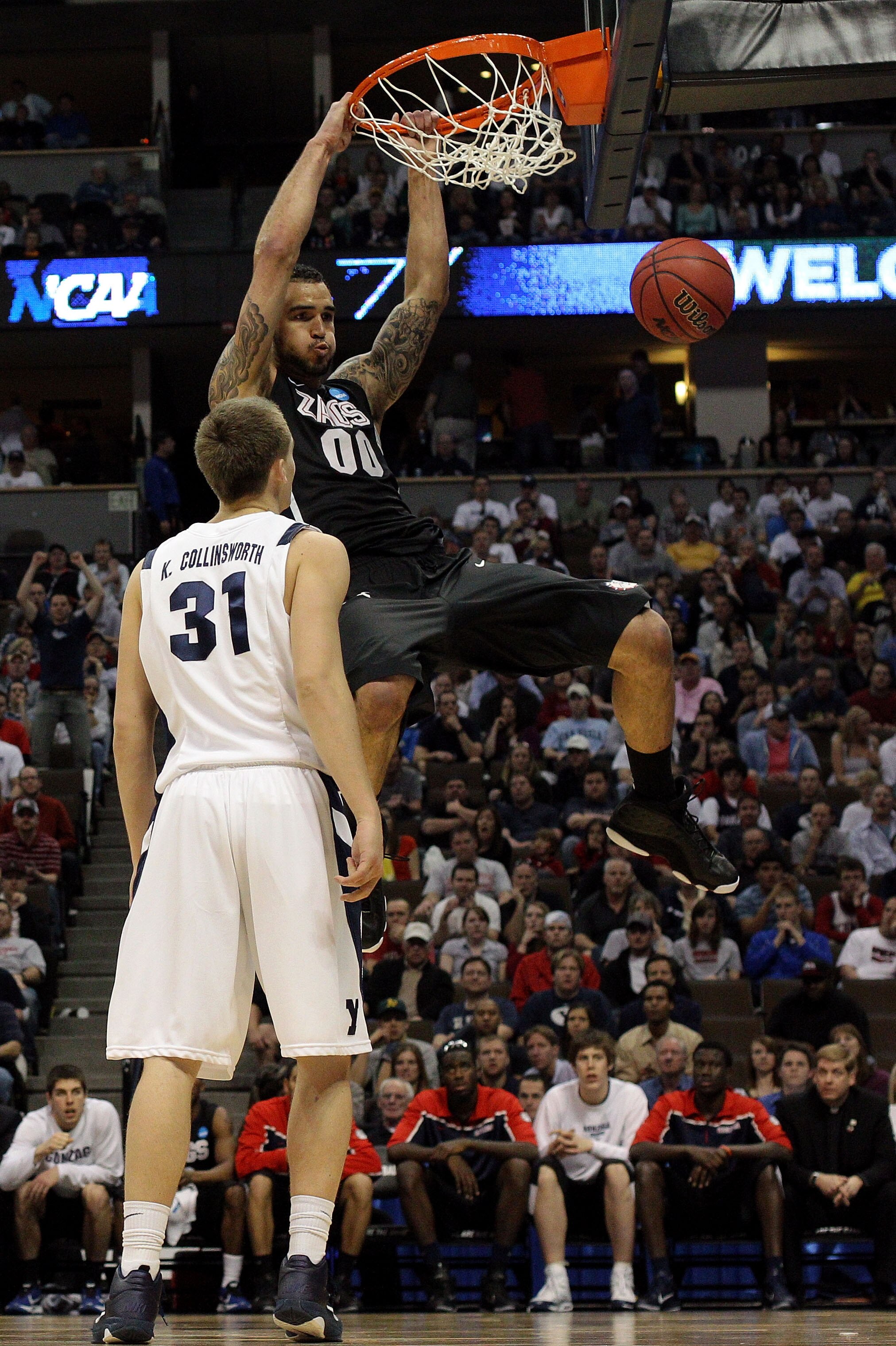 DENVER, CO - MARCH 19:  Robert Sacre #00 of the Gonzaga Bulldogs dunks the ball over Kyle Collinsworth #31 of the Brigham Young Cougars during the third round of the 2011 NCAA men's basketball tournament at Pepsi Center on March 19, 2011 in Denver, Colora