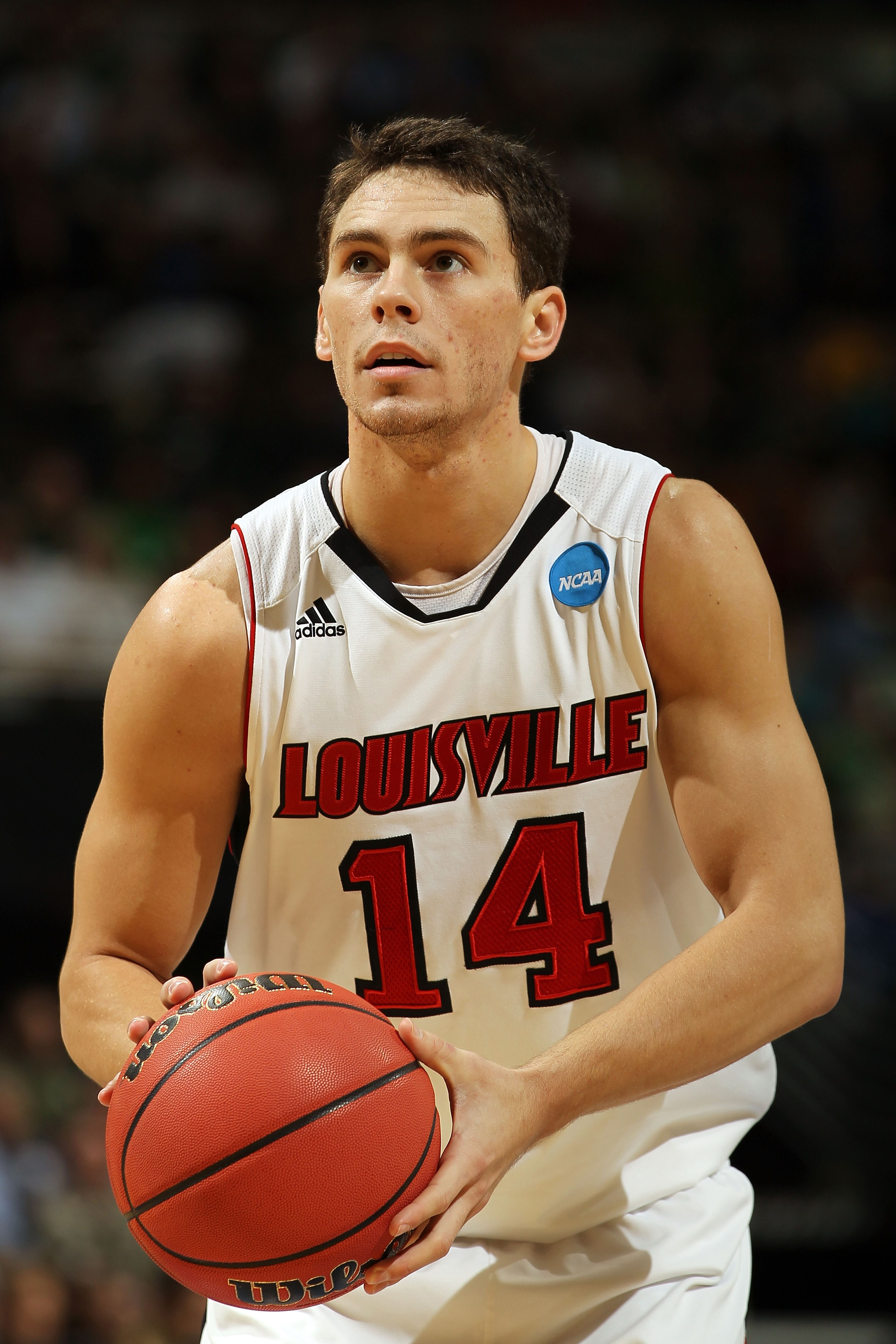 DENVER, CO - MARCH 17:  Kyle Kuric #14 of the Louisville Cardinals takes a free thow against the Morehead State Eagles during the second round of the 2011 NCAA men's basketball tournament at Pepsi Center on March 17, 2011 in Denver, Colorado.  (Photo by D