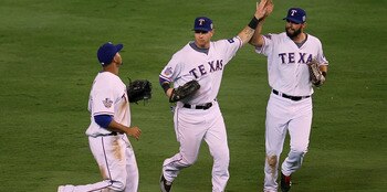 ARLINGTON, TX - OCTOBER 30:  (L-R) Nelson Cruz #17, Josh Hamilton #32 and Jeff Francoeur #21 of the Texas Rangers celebrate after their 4-2 win against the San Francisco Giants in Game Three of the 2010 MLB World Series at Rangers Ballpark in Arlington on