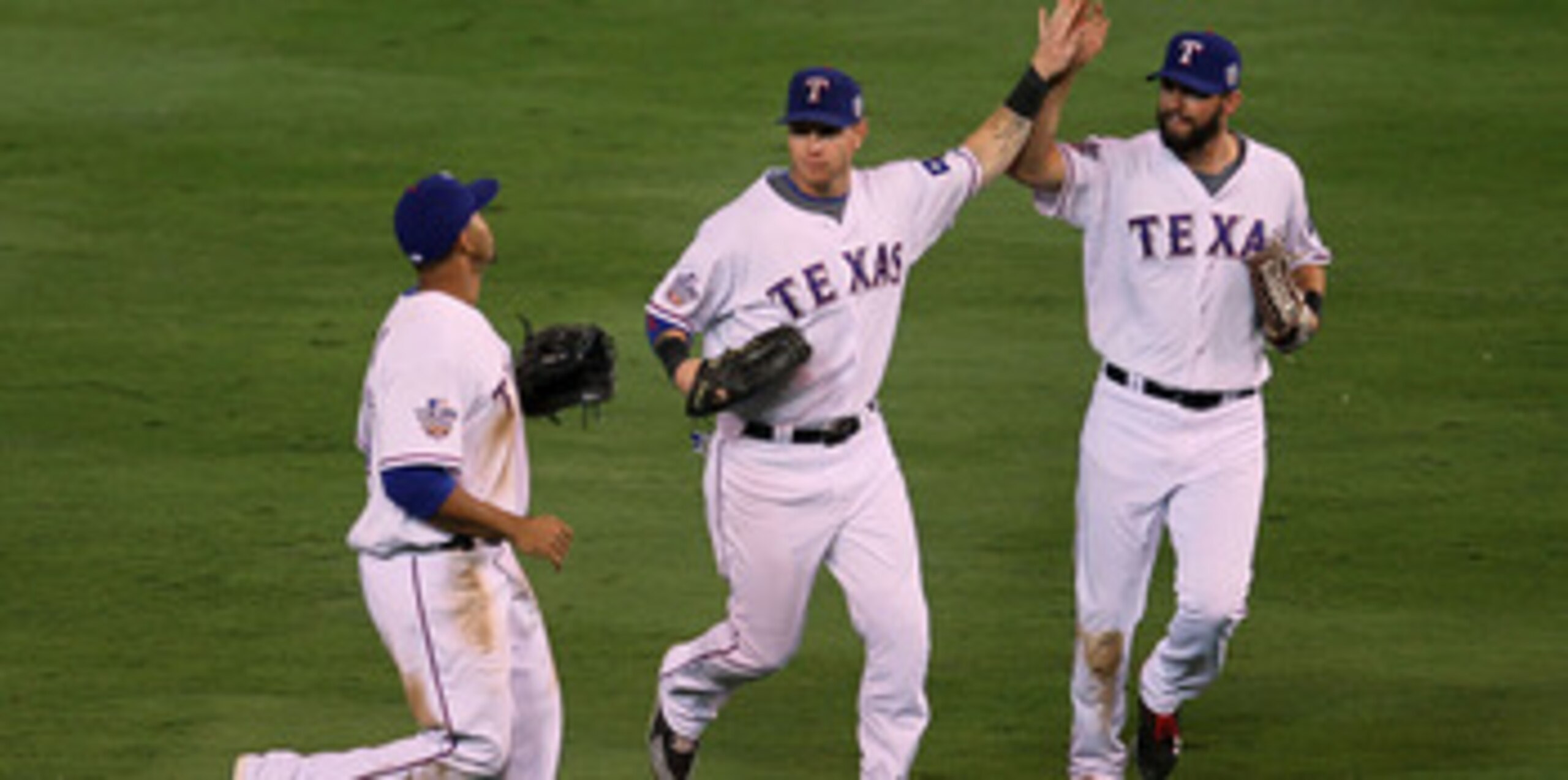 ARLINGTON, TX - OCTOBER 30:  (L-R) Nelson Cruz #17, Josh Hamilton #32 and Jeff Francoeur #21 of the Texas Rangers celebrate after their 4-2 win against the San Francisco Giants in Game Three of the 2010 MLB World Series at Rangers Ballpark in Arlington on