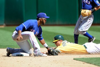 OAKLAND, CA - MAY 1: Elvis Andrus #1 of the Texas Rangers tags out Cliff Pennington #2 of the Oakland Athletics attempting to steal second base during a MLB baseball game at the Oakland-Alameda County Coliseum May 1, 2011 in Oakland, California. (Photo by