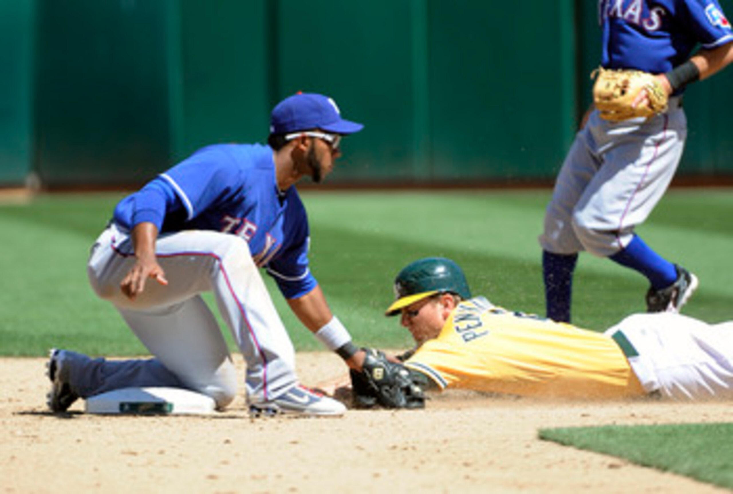 OAKLAND, CA - MAY 1: Elvis Andrus #1 of the Texas Rangers tags out Cliff Pennington #2 of the Oakland Athletics attempting to steal second base during a MLB baseball game at the Oakland-Alameda County Coliseum May 1, 2011 in Oakland, California. (Photo by