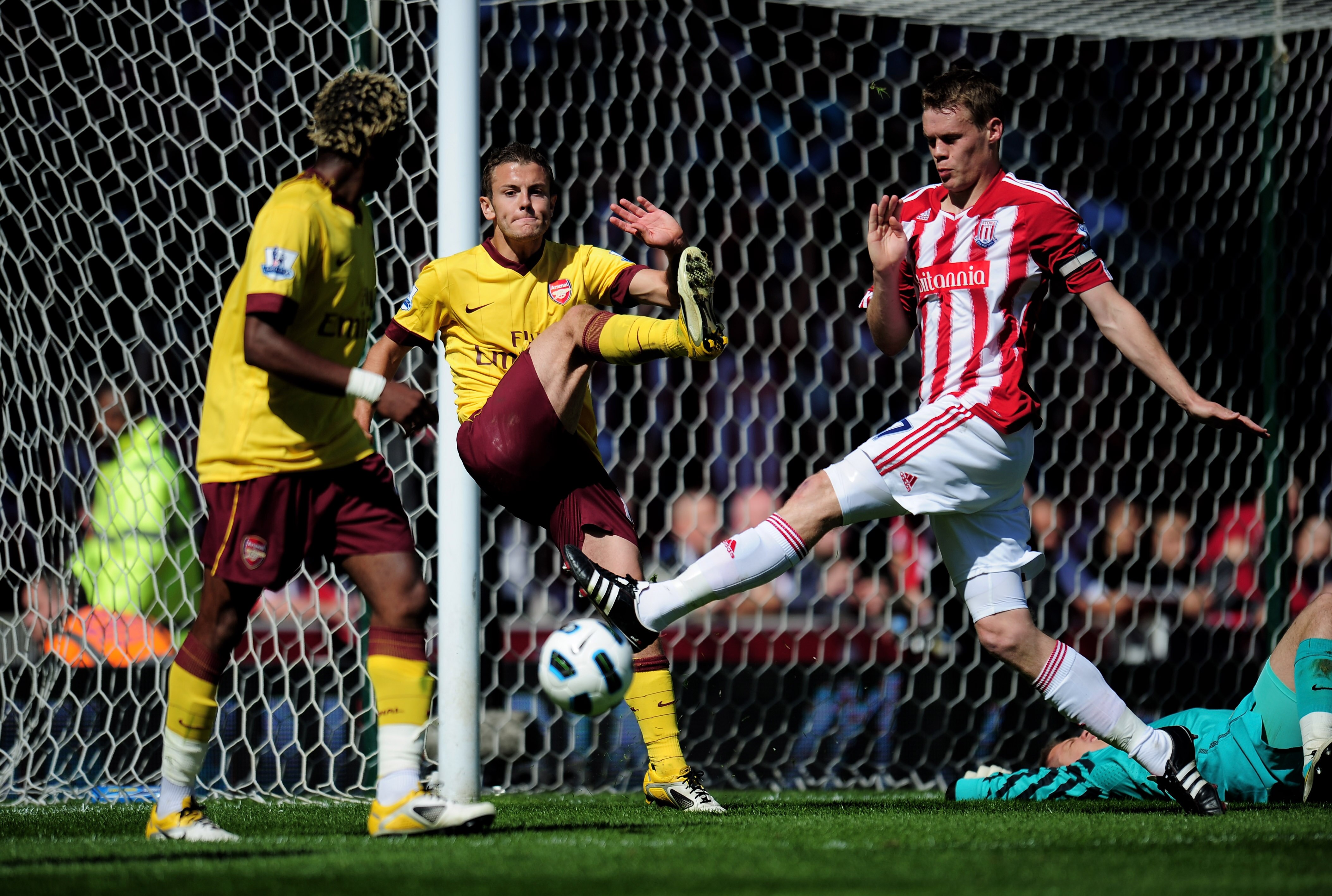 STOKE ON TRENT, ENGLAND - MAY 08:  Jack Wilshere of Arsenal clears the ball off his own goal line as Ryan Shawcross of Stoke closes in during the Barclays Premier League match between Stoke City and Arsenal at the Britannia Stadium on May 8, 2011 in Stoke