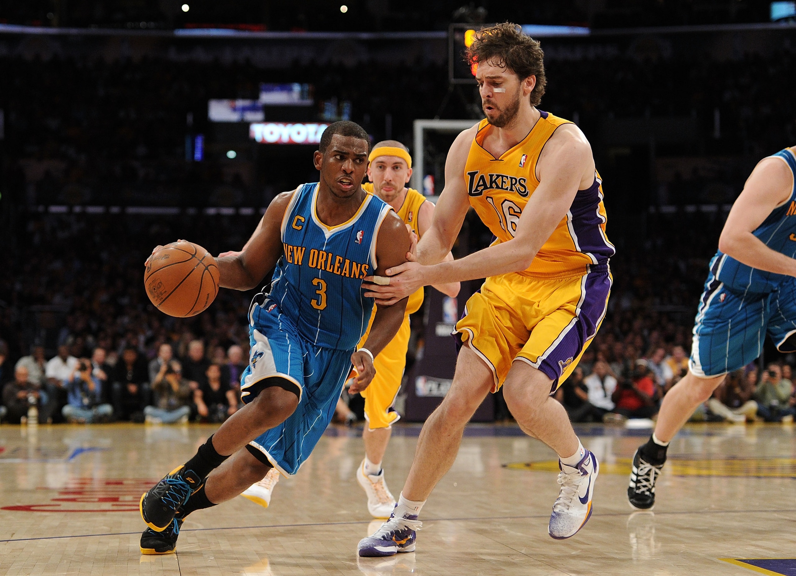 LOS ANGELES, CA - APRIL 20:  Chris Paul #3 of the New Orleans Hornets drives on Pau Gasol #16 of the Los Angeles Lakers in Game Two of the Western Conference Quarterfinals in the 2011 NBA Playoffs on April 20, 2011 at Staples Center in Los Angeles, Califo