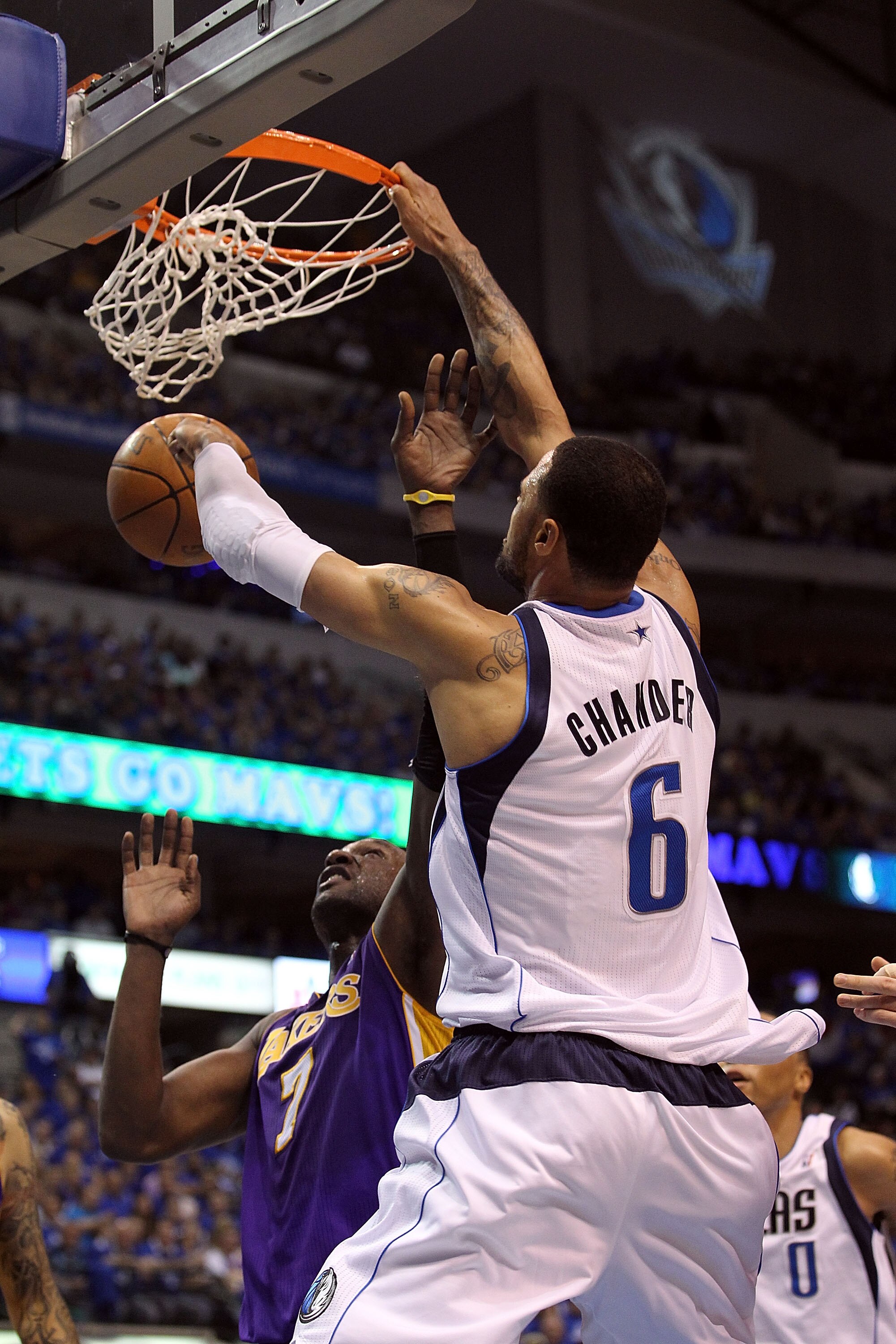 DALLAS, TX - MAY 06:  Center Tyson Chandler #6 of the Dallas Mavericks gets the slam dunk against Lamar Odom #7 of the Los Angeles Lakers in Game Three of the Western Conference Semifinals during the 2011 NBA Playoffs on May 6, 2011 at American Airlines C