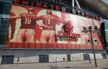 LONDON, ENGLAND - APRIL 11:  Boys play football in front of Arsenal Football Club's Emirates Stadium on April 11, 2011 in London, England. American businessman Stan Kroenke's company 'Kroenke Sports Enterprises' has increased its shareholding in Arsenal t