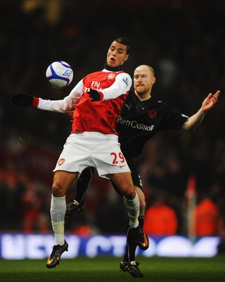 LONDON, UNITED KINGDOM - MARCH 02:  Marouane Chamakh (L) of Arsenal holds off the challenge of Andrew Whing (R) of Leyton Orient during the FA Cup sponsored by E.ON 5th Round Replay match between between Arsenal and Leyton Orient at the Emirates Stadium o