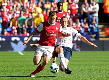 BOLTON, ENGLAND - APRIL 24:  Kevin Davies of Bolton Wanderers challenges Jack Wilshere of Arsenal during the Barclays Premier League match between Bolton Wanderers and Arsenal at the Reebok Stadium on April 24, 2011 in Bolton, England.  (Photo by Michael 