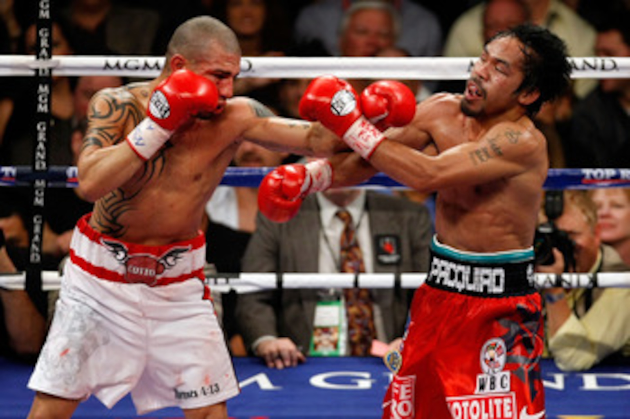 LAS VEGAS - NOVEMBER 14:  (L-R) Miguel Cotto of Puerto Rico throws a left to the head of Manny Pacquiao during their WBO welterweight title fight at the MGM Grand Garden Arena on November 14, 2009 in Las Vegas, Nevada. Pacquiao defeated Cotto by 12th roun