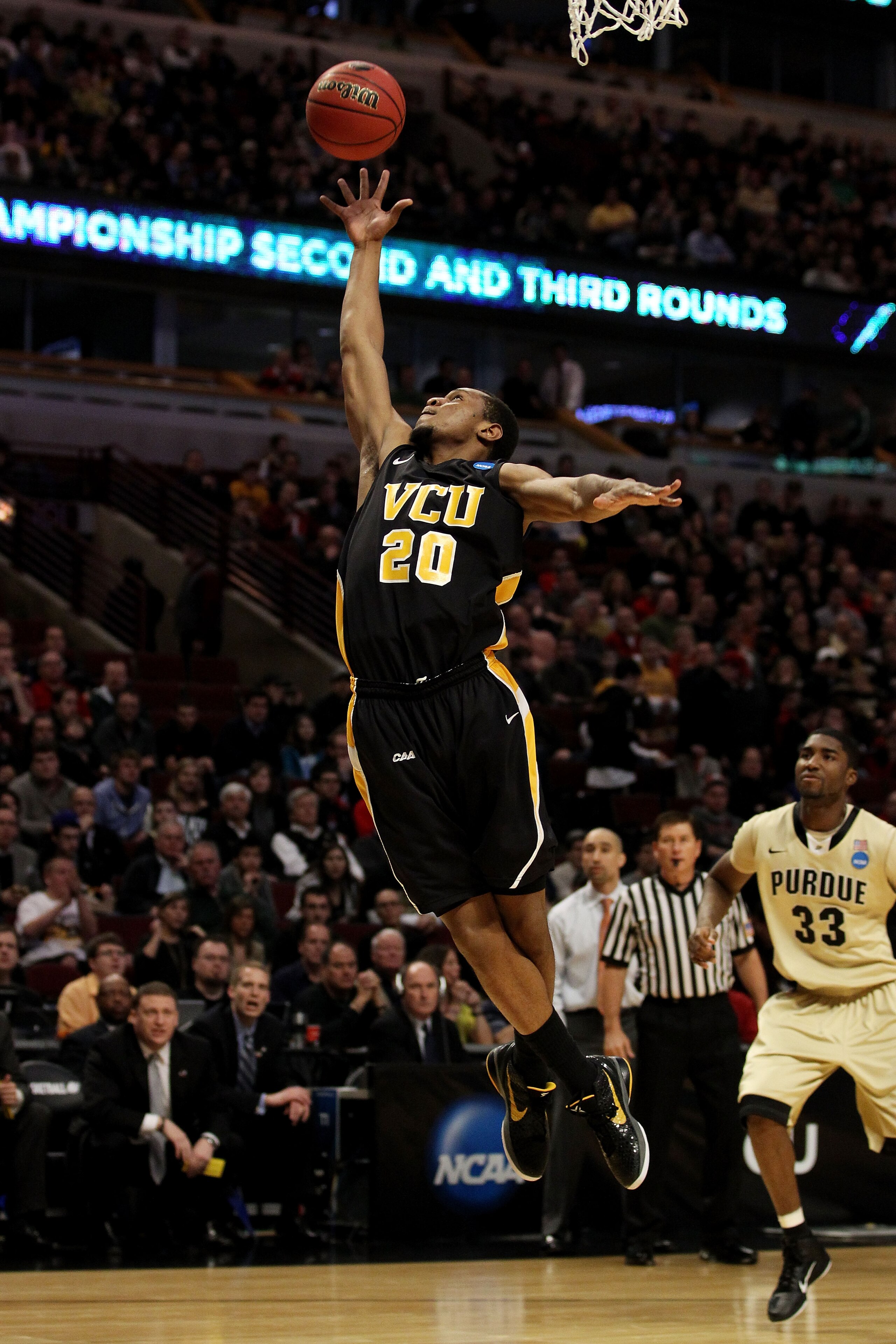 CHICAGO, IL - MARCH 20:  Bradford Burgess #20 of the Virginia Commonwealth Rams rebounds the ball against E'Twaun Moore #33 of the Purdue Boilermakers in the first half during the third round of the 2011 NCAA men's basketball tournament at the United Cent