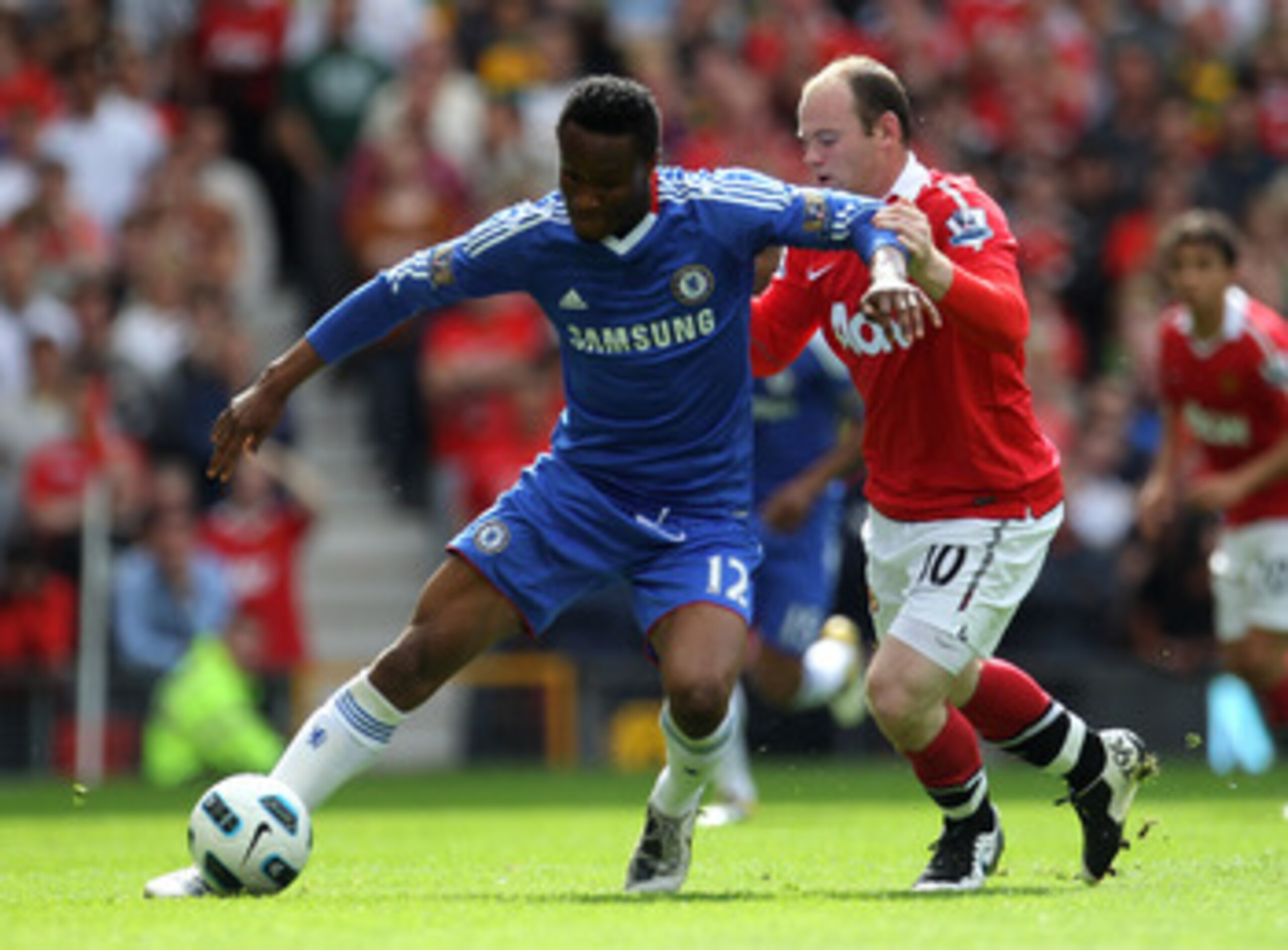 MANCHESTER, ENGLAND - MAY 08:  John Obi Mikel of Chelsea is challenged by Wayne Rooney of Manchester United during the Barclays Premier League match between Manchester United and Chelsea at Old Trafford on May 8, 2011 in Manchester, England.  (Photo by Al