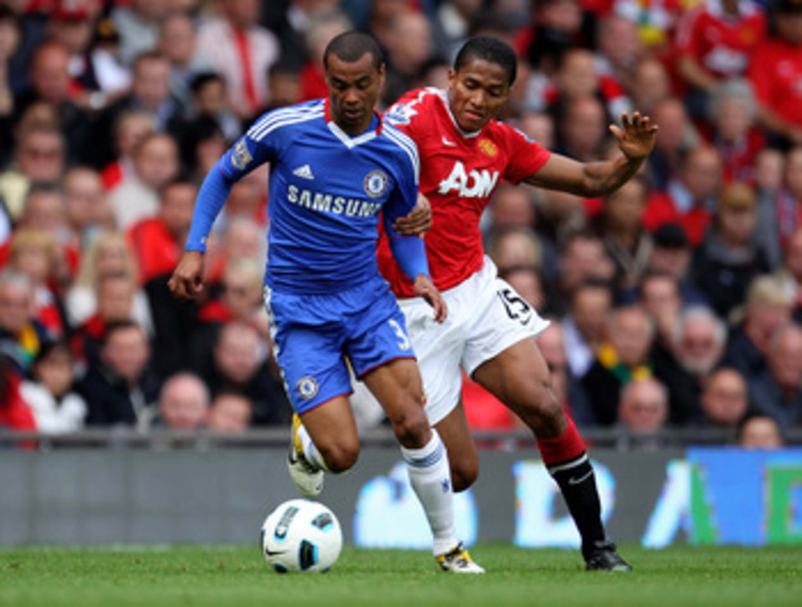MANCHESTER, ENGLAND - MAY 08:  Antonio Valencia of Manchester United tussles for posession with Ashley Cole of Chelsea during the Barclays Premier League match between Manchester United and Chelsea at Old Trafford on May 8, 2011 in Manchester, England.  (