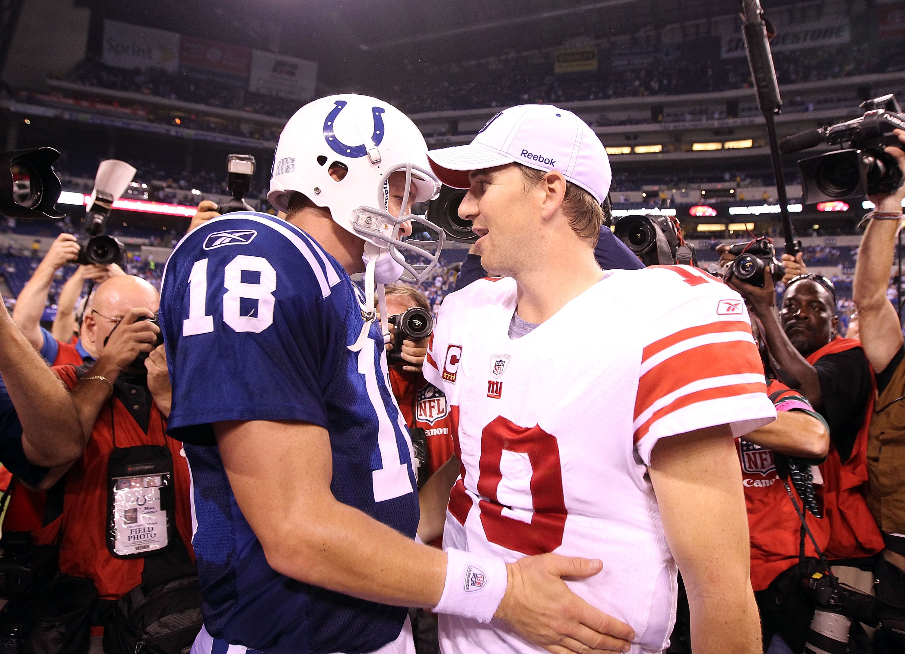 INDIANAPOLIS - SEPTEMBER 19:  Eli Manning #10 of the New York Giants and Peyton Manning #18 of the Indianapolis Colts embrace following the Colts 38-14 win at Lucas Oil Stadium on September 19, 2010 in Indianapolis, Indiana.  (Photo by Andy Lyons/Getty Im
