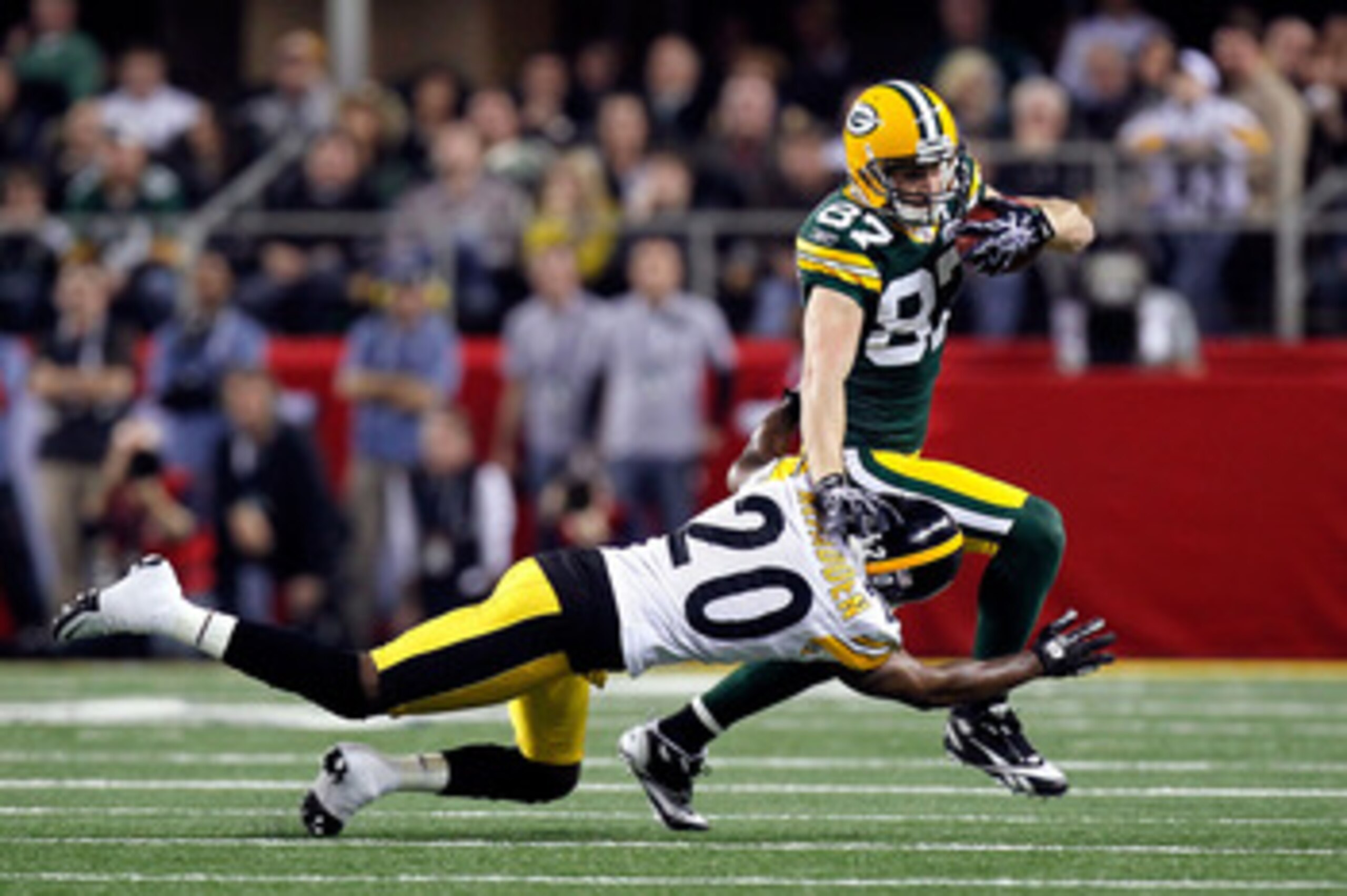 ARLINGTON, TX - FEBRUARY 06:  Jordy Nelson #87 of the Green Bay Packers runs for yards after the catch against Bryant McFadden #20 of the Pittsburgh Steelers during Super Bowl XLV at Cowboys Stadium on February 6, 2011 in Arlington, Texas.  (Photo by Kevi