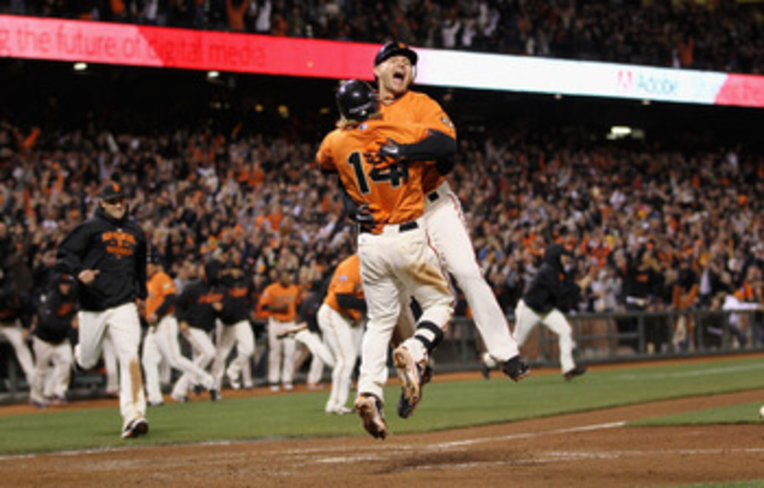 SAN FRANCISCO, CA - MAY 06:  Cody Ross #13 and Mike Fontenot #14 of the San Francisco Giants celebrate after Ross scored the winning run on a hit by Freddy Sanchez #21 in the bottom of the ninth inning against the Colorado Rockies at AT&T Park on May 6, 2