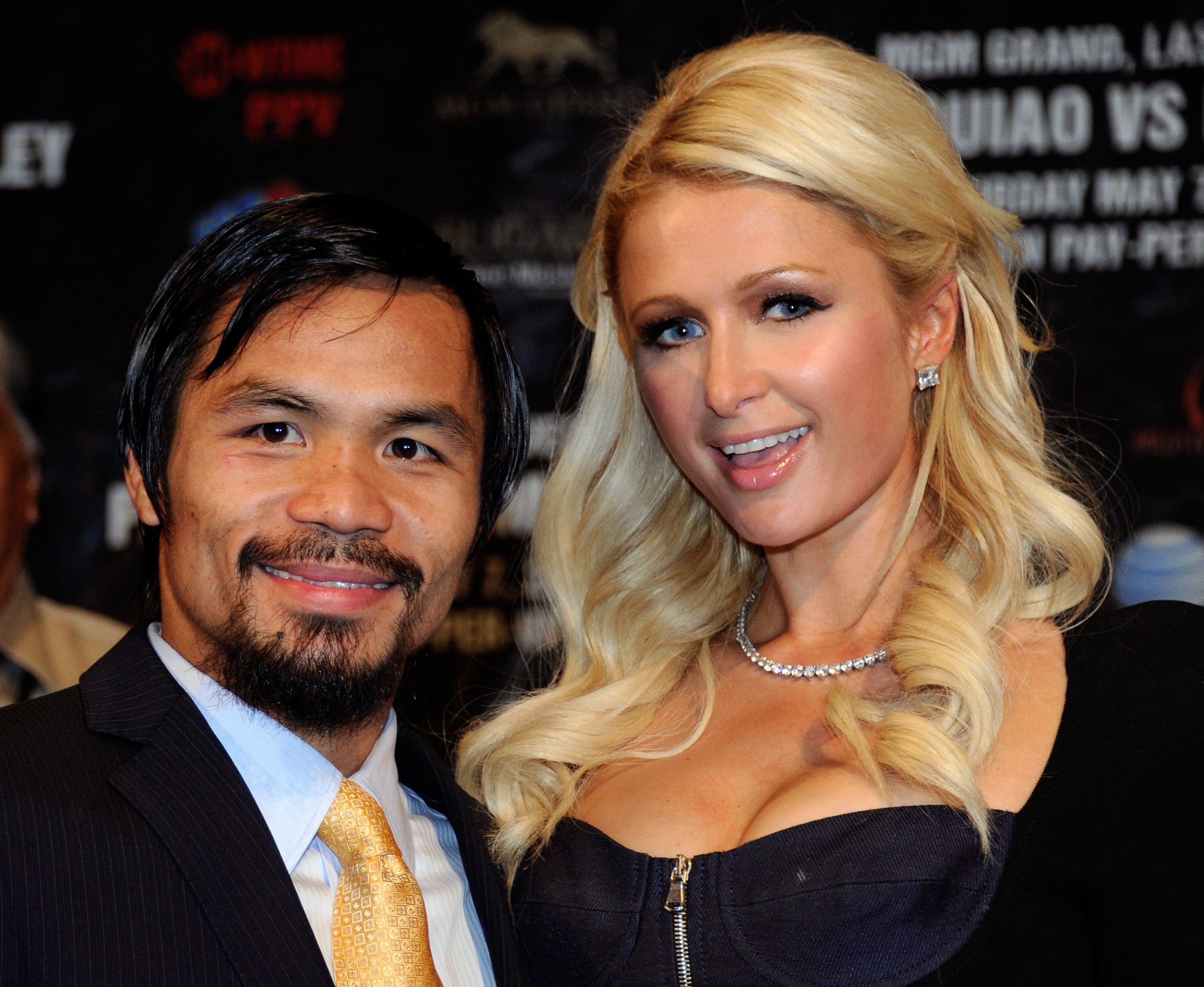 LAS VEGAS, NV - MAY 07:  Boxer Manny Pacquiao (L) poses with Paris Hilton at a post-fight news conference after Pacquiao defeated Shane Mosley by unanimous decision to retain his WBO welterweight title at the MGM Grand Garden Arena May 7, 2011 in Las Vega