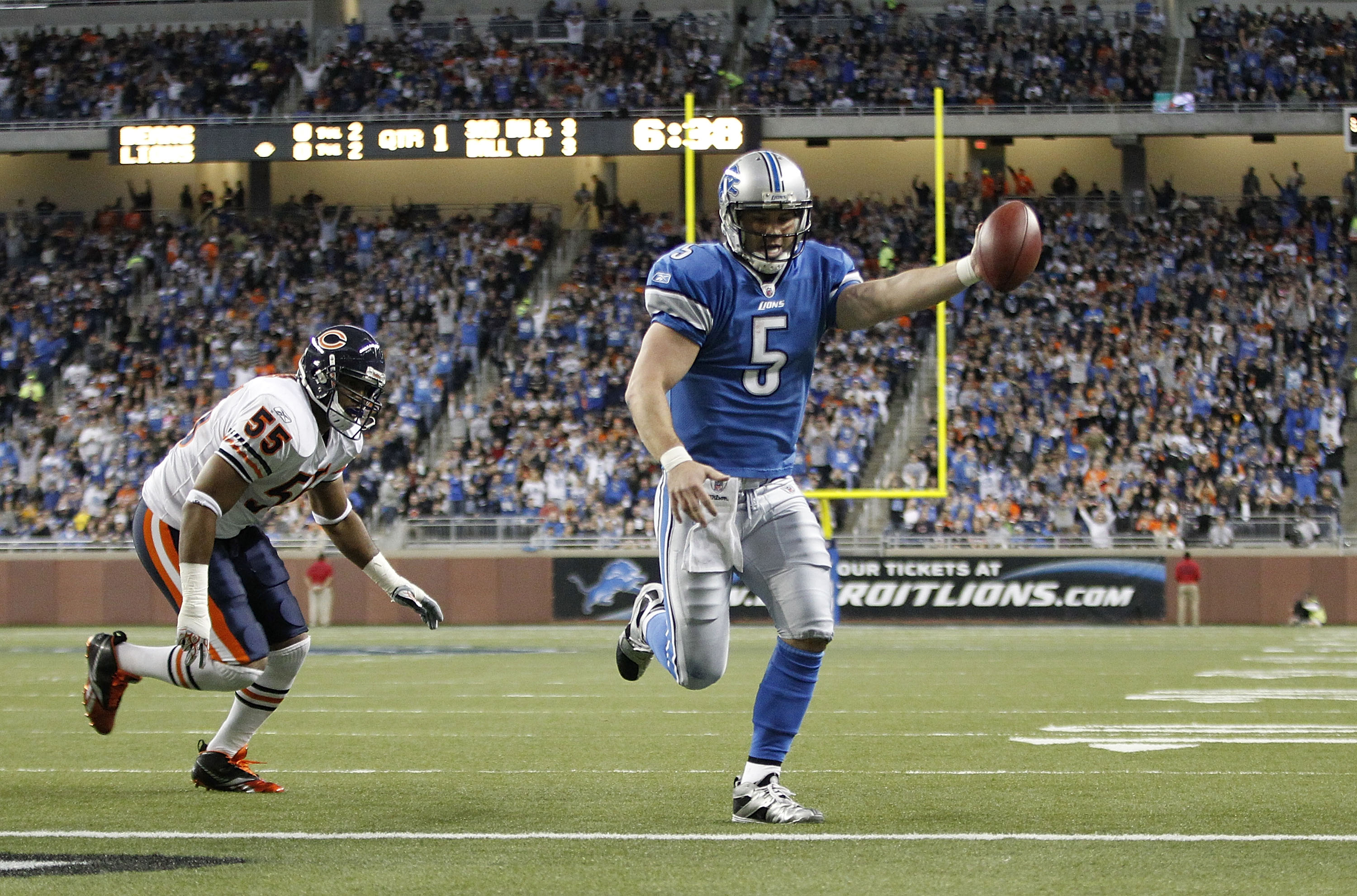 DETROIT - DECEMBER 05: Drew Stanton #5 of the Detroit Lions runs three yards for a first quarter touchdown as Lance Briggs #55 of the Chicago Bears gives chase during the game at Ford Field on December 5, 2010 in Detroit, Michigan.  (Photo by Leon Halip/G