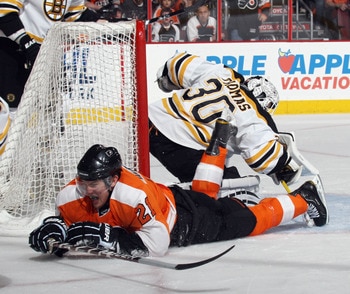 PHILADELPHIA, PA - APRIL 30:  Tim Thomas #30 of the Boston Bruins makes the save on James van Riemsdyk #21 of the Philadelphia Flyers in Game One of the Eastern Conference Semifinals during the 2011 NHL Stanley Cup Playoffs at the Wells Fargo Center on Ap