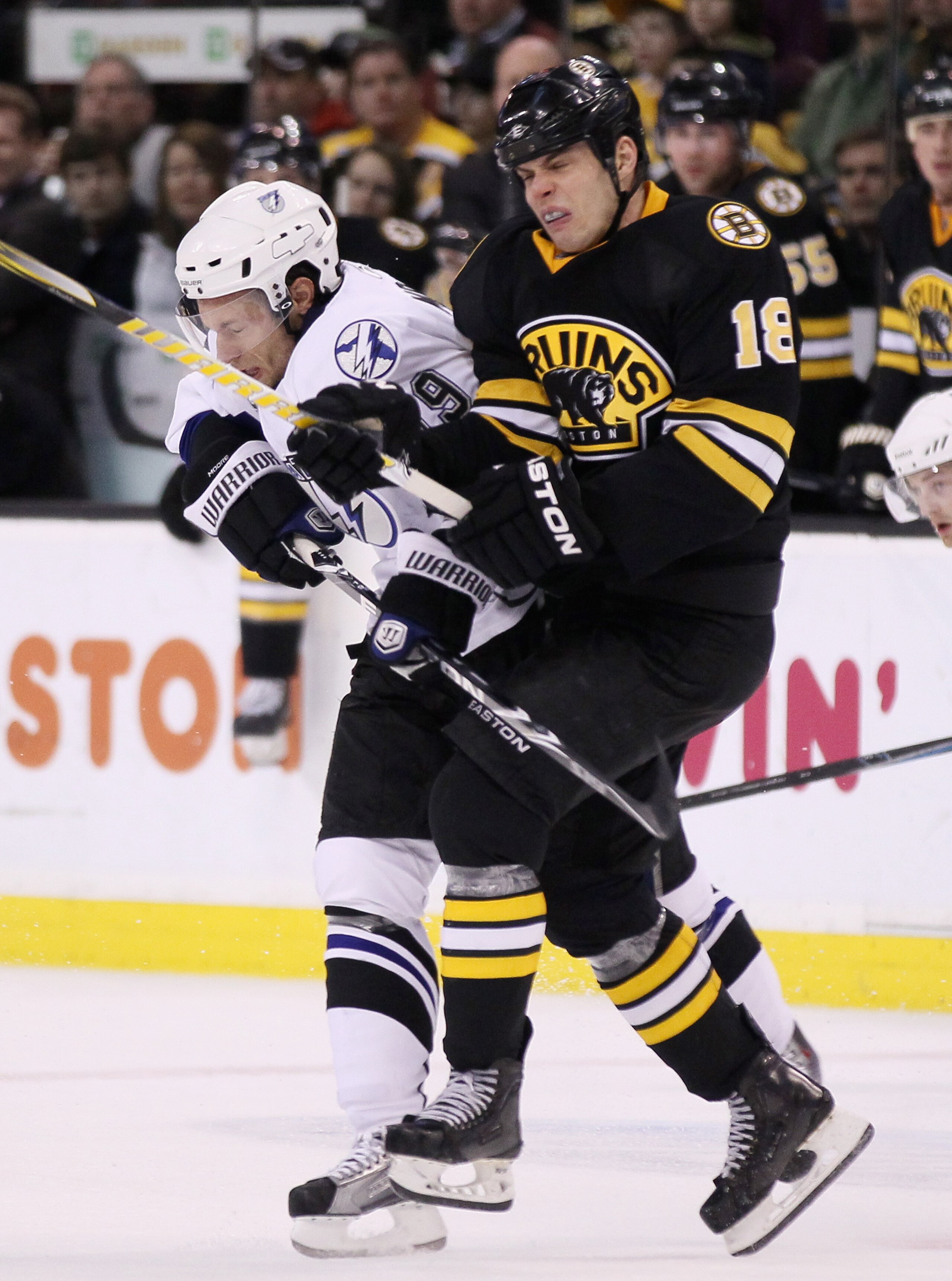 BOSTON, MA - MARCH 03:  Nathan Horton #18 of the Boston Bruins and Dominic Moore #19 of the Tampa Bay Lightning collide in the second period on March 3, 2011 at the TD Garden in Boston, Massachusetts.  (Photo by Elsa/Getty Images)