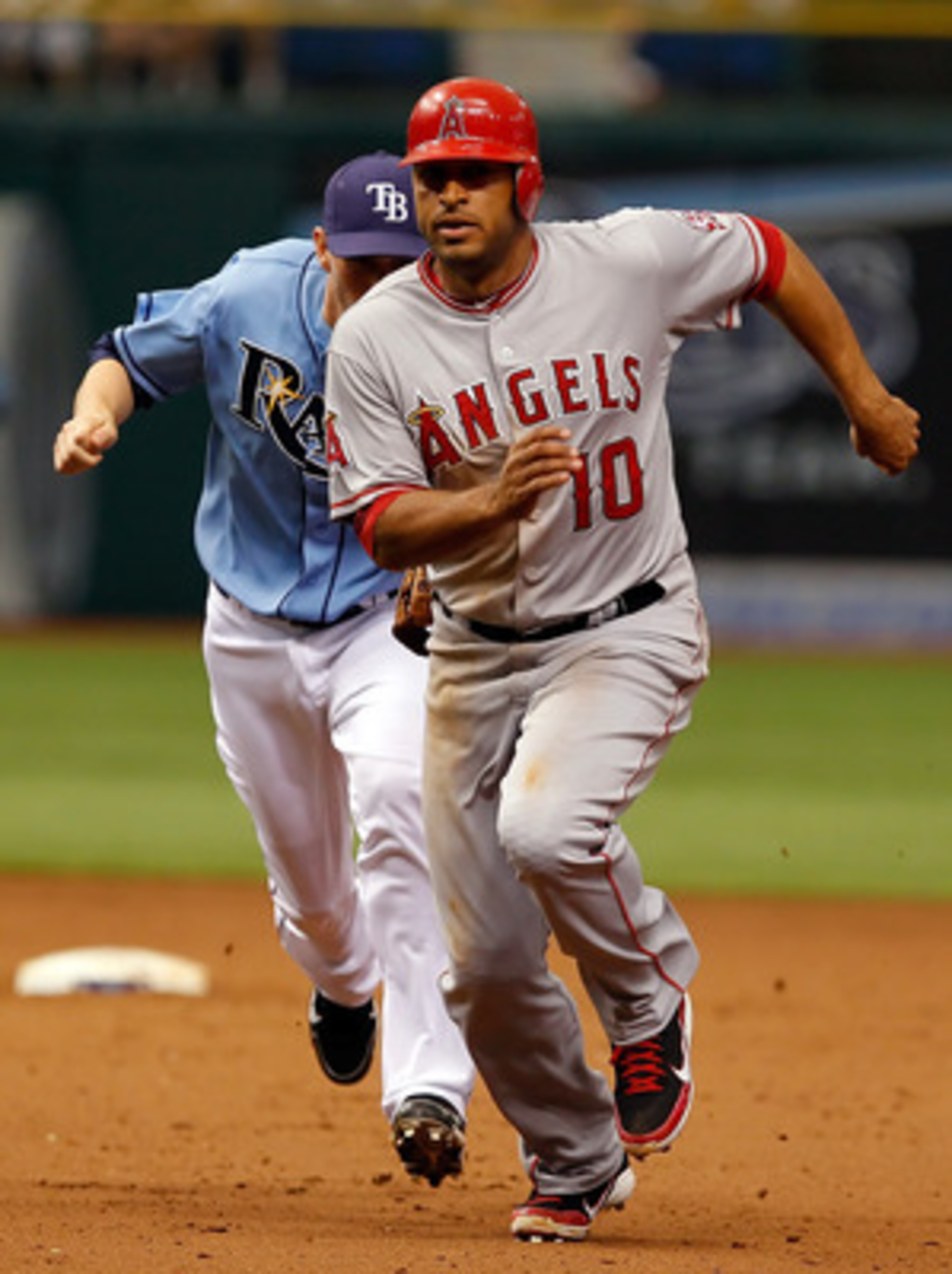 ST. PETERSBURG, FL - MAY 01:  Outfielder Vernon Wells #10 of the Los Angeles Angels of Anaheim gets caught in a run down in the eighth inning as shortstop Reid Brignac #15 of the Tampa Bay Rays tags him out during the game at Tropicana Field on May 1, 201