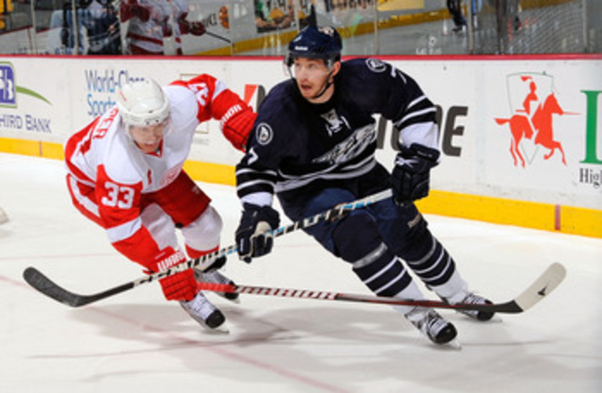NASHVILLE, TN - APRIL 02:  Kris Draper #33 of the Detroit Red Wings skates against Jonathon Blum #7 of the Nashville Predators on April 2, 2011 at the Bridgestone Arena in Nashville, Tennessee.  (Photo by Frederick Breedon/Getty Images)