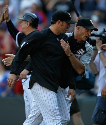 CHICAGO - JUNE 25: Coach Kevin Hickey of the Chicago White Sox (R) congratulates pitcher Jake Peavy after a win over the Chicago Cubs at U.S. Cellular Field on June 25, 2010 in Chicago, Illinois. The White Sox defeated the Cubs 6-0. (Photo by Jonathan Dan