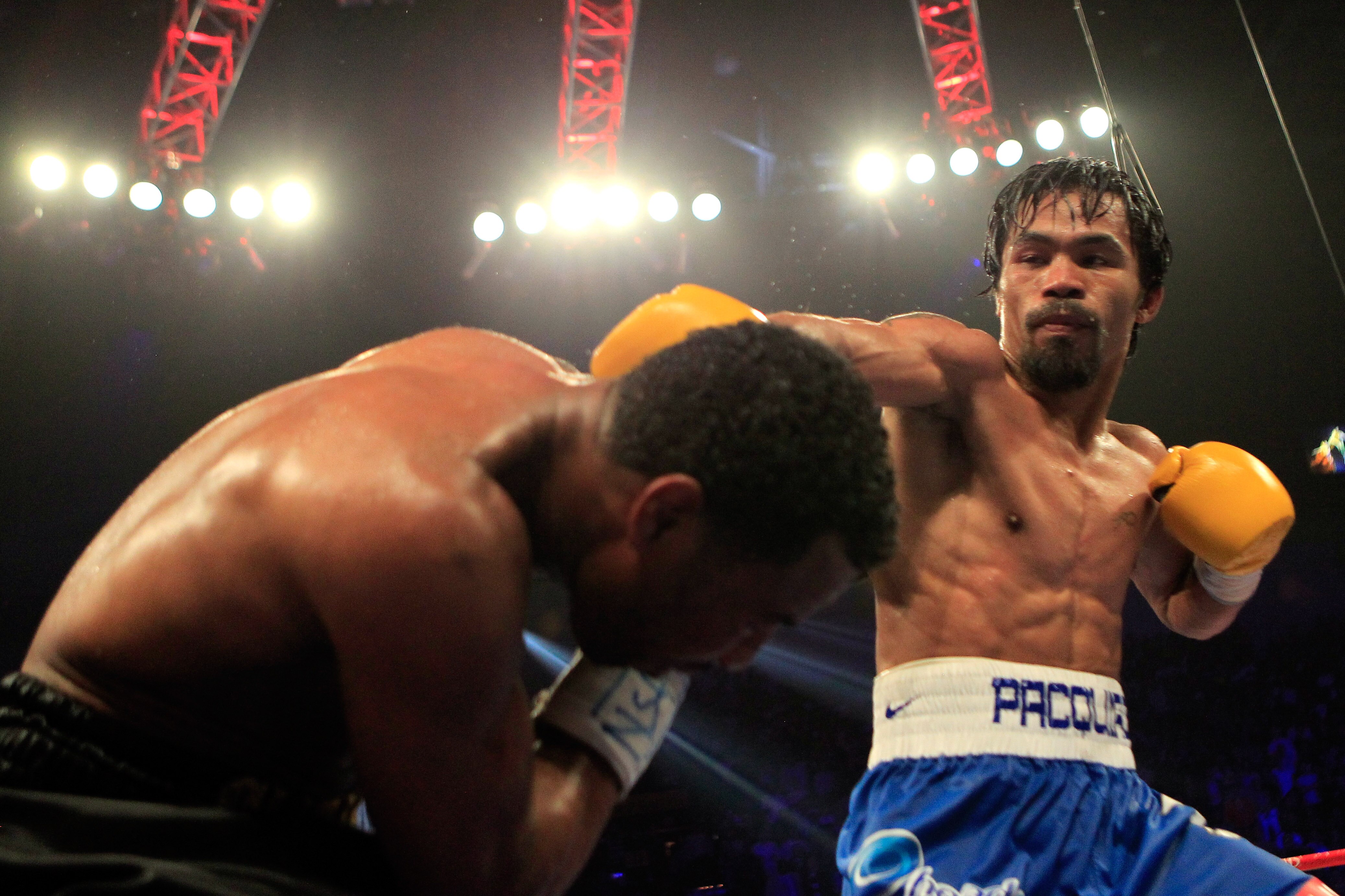 LAS VEGAS, NV - MAY 07:  (R-L) Manny Pacquiao of the Philippines throws a right at Shane Mosley in the WBO welterweight title fight at MGM Grand Garden Arena on May 7, 2011 in Las Vegas, Nevada.  (Photo by Chris Trotman/Getty Images)