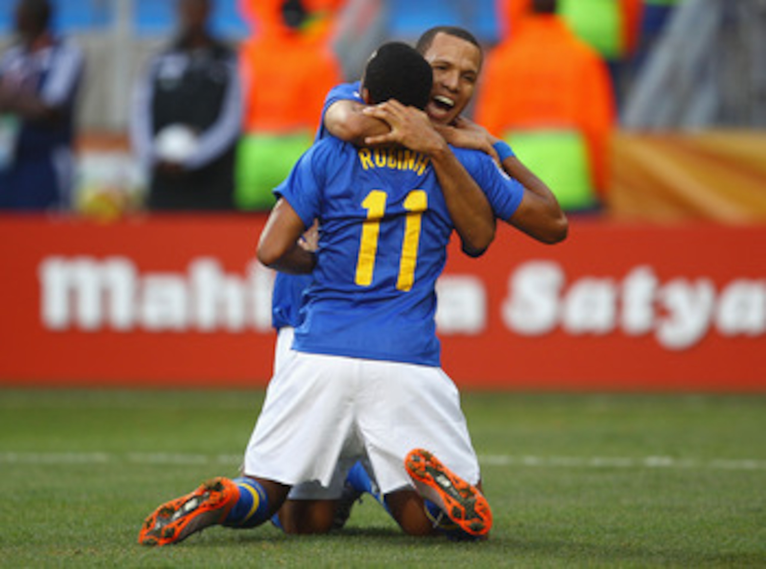 PORT ELIZABETH, SOUTH AFRICA - JULY 02:  Luis Fabiano congratulates Robinho of Brazil after he scored the opening goal during the 2010 FIFA World Cup South Africa Quarter Final match between Netherlands and Brazil at Nelson Mandela Bay Stadium on July 2, 