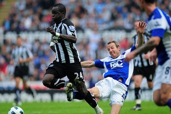 NEWCASTLE UPON TYNE, ENGLAND - MAY 07:  Birmingham player Lee Bowyer (C) fouls Chiek Tiote of Newcastle during the Barclays Premier League game between Newcastle United and Birmingham City at St James' Park on May 7, 2011 in Newcastle upon Tyne, England.