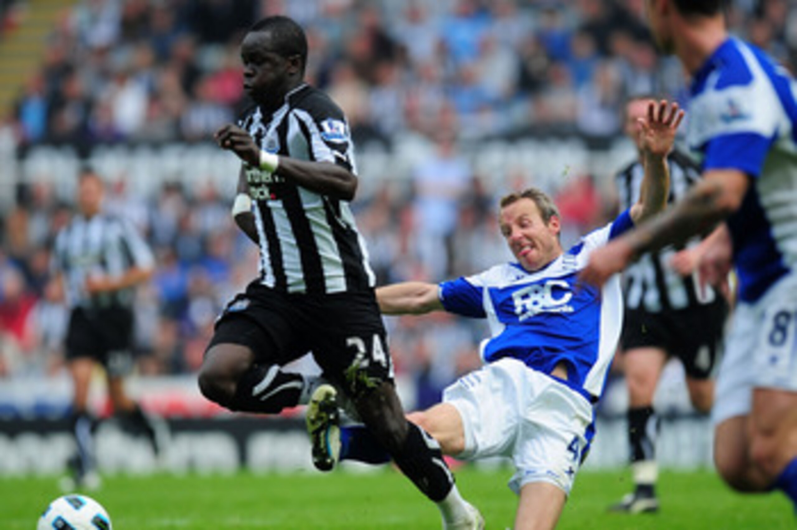 NEWCASTLE UPON TYNE, ENGLAND - MAY 07:  Birmingham player Lee Bowyer (C) fouls Chiek Tiote of Newcastle during the Barclays Premier League game between Newcastle United and Birmingham City at St James' Park on May 7, 2011 in Newcastle upon Tyne, England.