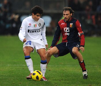 GENOA, ITALY - OCTOBER 29: Coutinho of FC Internazionale Milano shields the ball from Marco Rossi of Genoa CFCduring the Serie A match between Genoa CFC  and FC Inter Milan at Stadio Luigi Ferraris on October 29, 2010 in Genoa, Italy.  (Photo by Massimo C