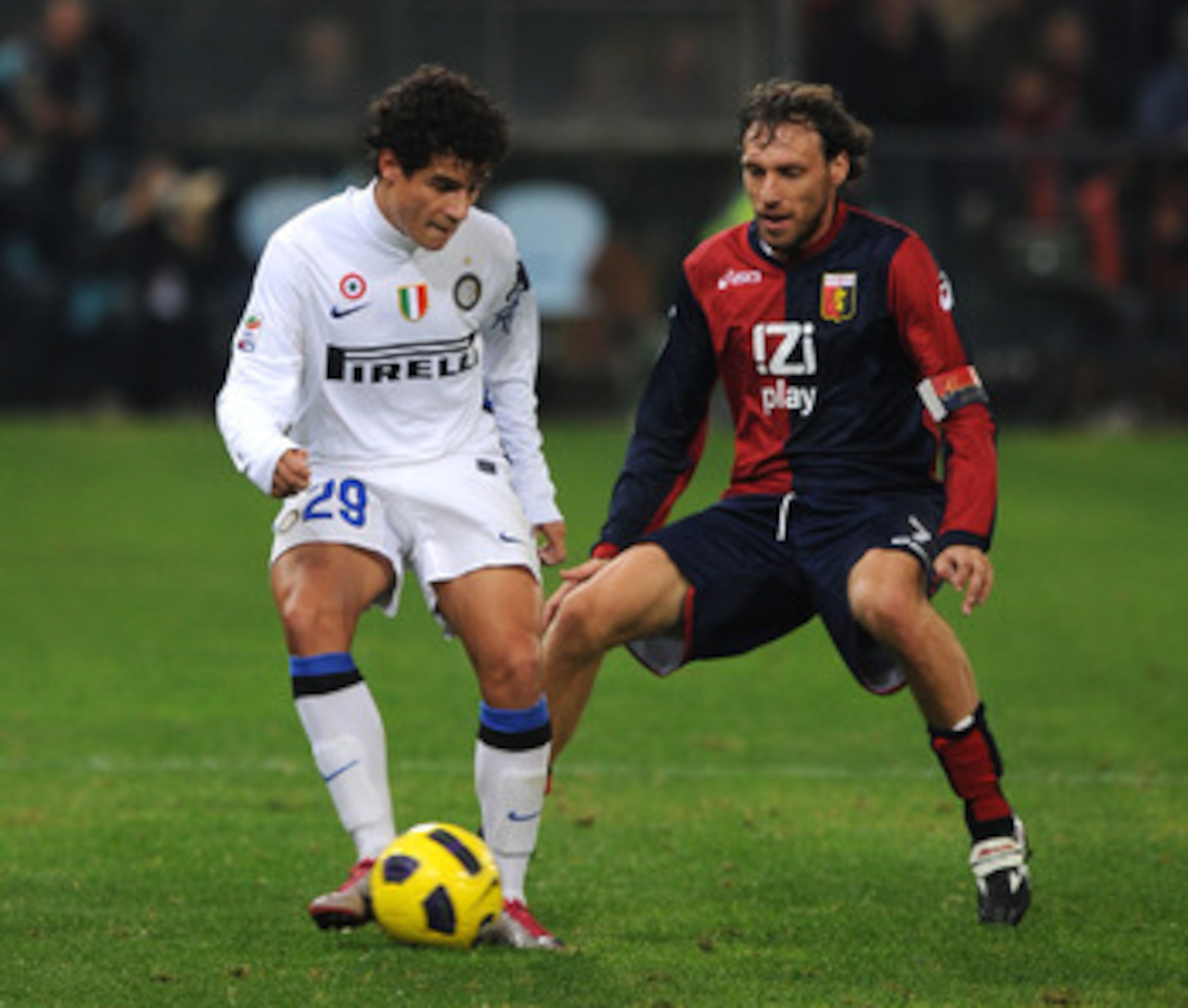 GENOA, ITALY - OCTOBER 29: Coutinho of FC Internazionale Milano shields the ball from Marco Rossi of Genoa CFCduring the Serie A match between Genoa CFC  and FC Inter Milan at Stadio Luigi Ferraris on October 29, 2010 in Genoa, Italy.  (Photo by Massimo C
