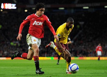 MANCHESTER, ENGLAND - MARCH 12:  Rafael Da Silva of Manchester United and Abou Diaby of Arsenal battle for the ball during the FA Cup sponsored by E.On Sixth Round match between Manchester United and Arsenal at Old Trafford on March 12, 2011 in Manchester