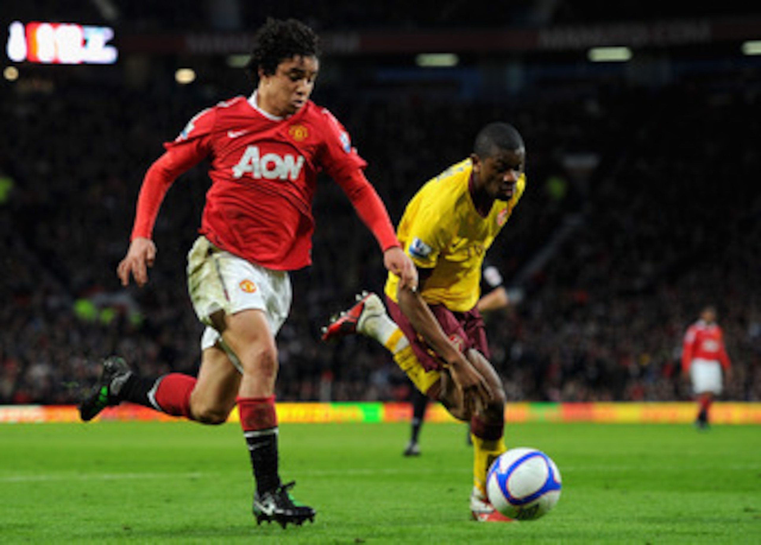 MANCHESTER, ENGLAND - MARCH 12:  Rafael Da Silva of Manchester United and Abou Diaby of Arsenal battle for the ball during the FA Cup sponsored by E.On Sixth Round match between Manchester United and Arsenal at Old Trafford on March 12, 2011 in Manchester
