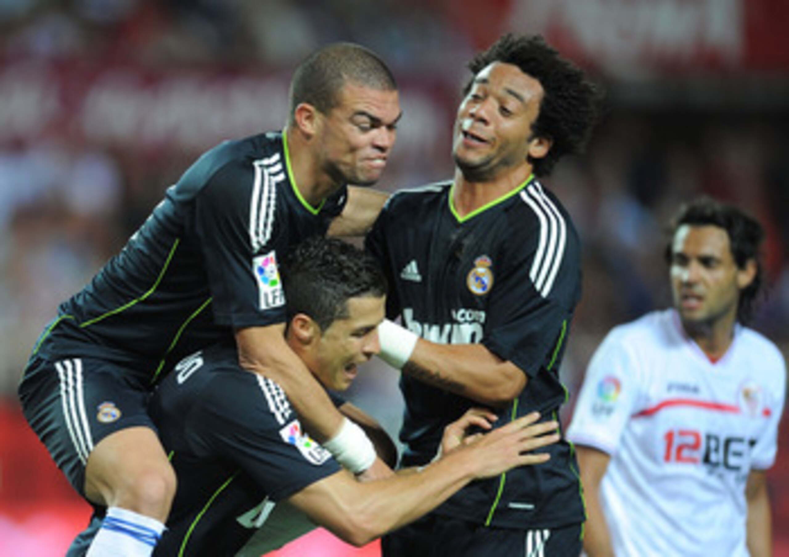 SEVILLE, SPAIN - MAY 07: Cristiano Ronaldo (C) of Real Madrid celebrates with Pepe (L) and Marcelo   after Ronaldo scored Real's second goal during the La Liga match between Sevilla and Real Madrid at Estadio Ramon Sanchez Pizjuan on May 7, 2011 in Sevill
