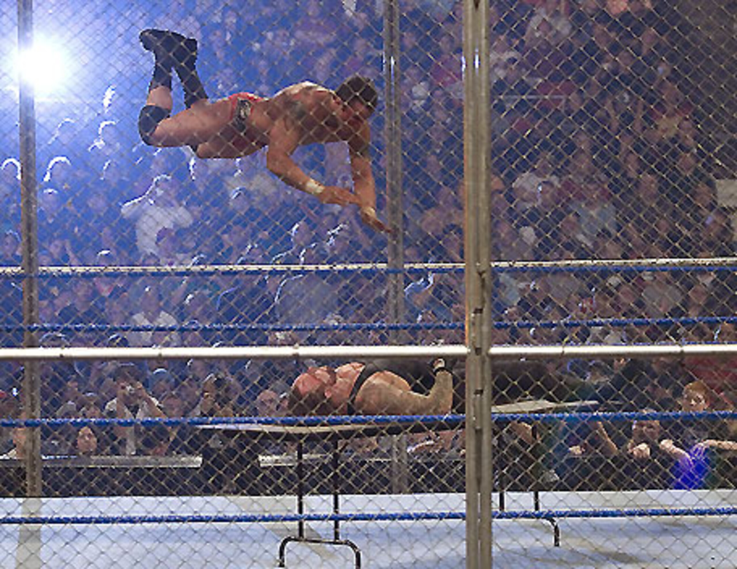 Orton diving onto Undertaker from up high