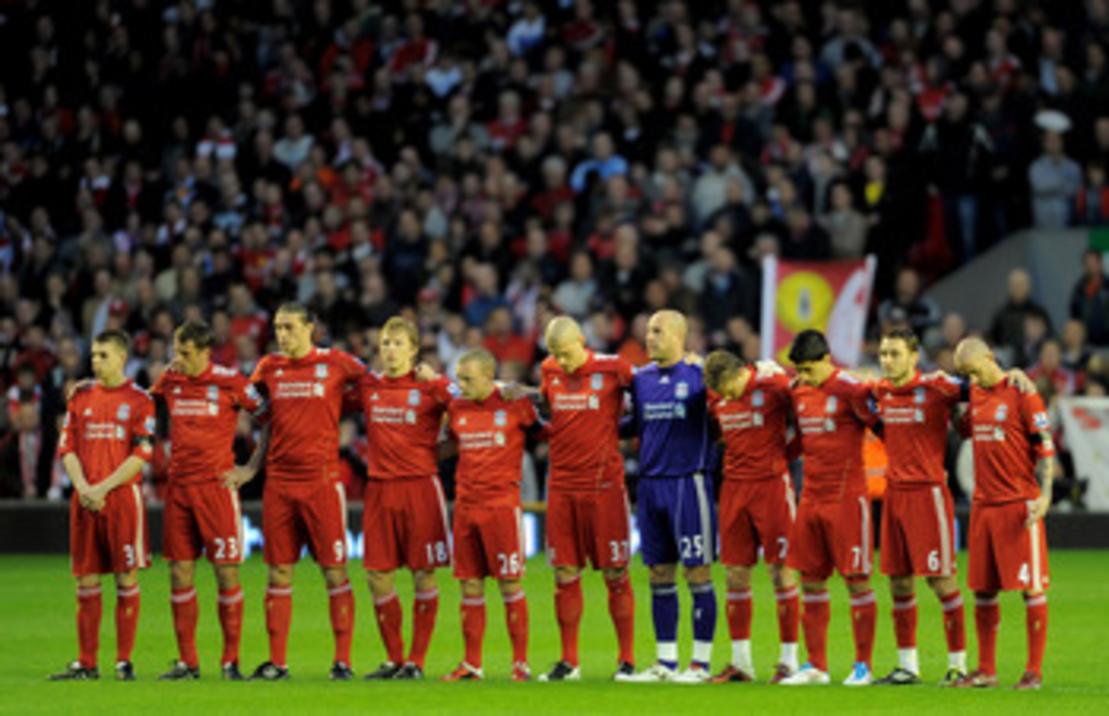 LIVERPOOL, ENGLAND - APRIL 11:  The Liverpool  players acknowledge a minutes silence in memory of the victims of the Hillsborough disaster prior to the Barclays Premier League match between Liverpool and Manchester City at Anfield on April 11, 2011 in Liv