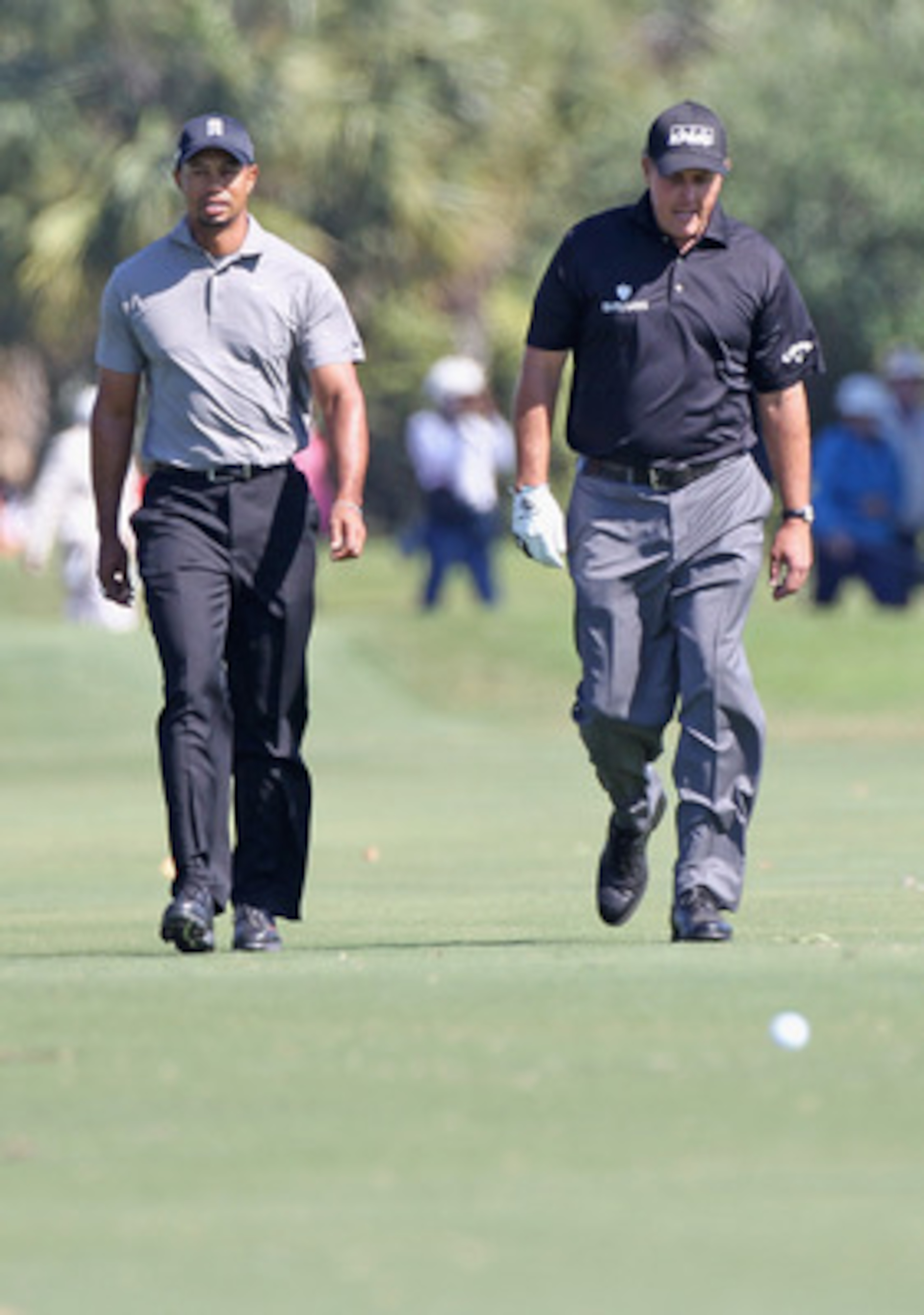 MIAMI, FL - MARCH 11:  Tiger Woods (L) walks up the seventh fairway alongside Phil Mickelson during the second round of the 2011 WGC- Cadillac Championship at the TPC Blue Monster at the Doral Golf Resort and Spa on March 11, 2011 in Doral, Florida.  (Pho