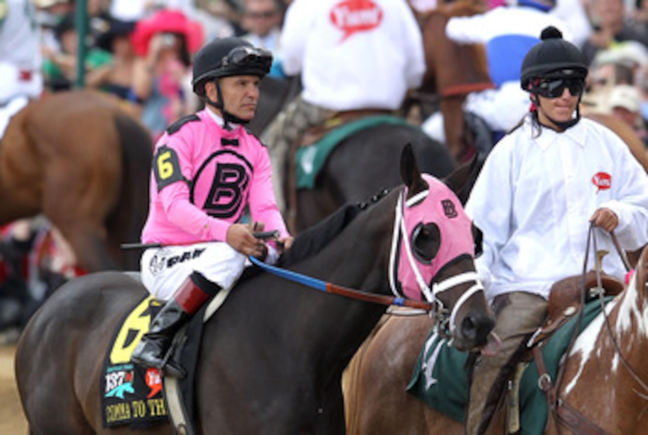 LOUISVILLE, KY - MAY 07:  Jockey Patrick Valenzuela, riding Comma to the Top #6, is escourted onto the track by an outrider for the running of the 137th Kentucky Derby at Churchill Downs on May 7, 2011 in Louisville, Kentucky.  (Photo by Matthew Stockman/