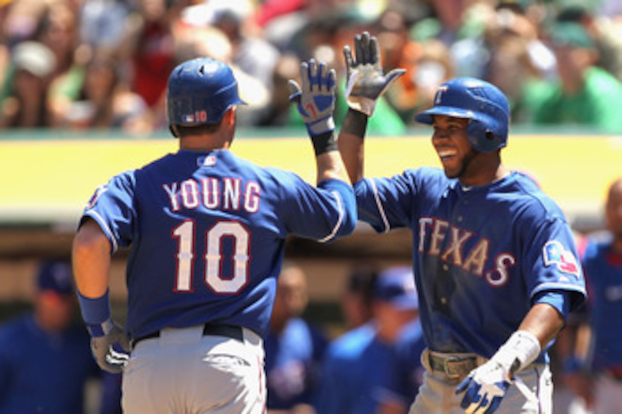 OAKLAND, CA - APRIL 30:  Michael Young #10 of the Texas Rangers is congratulated by Elvis Andrus #1 of the Texas Rangers after Young hit a home run against the Oakland Athletics at Oakland-Alameda County Coliseum on April 30, 2011 in Oakland, California.