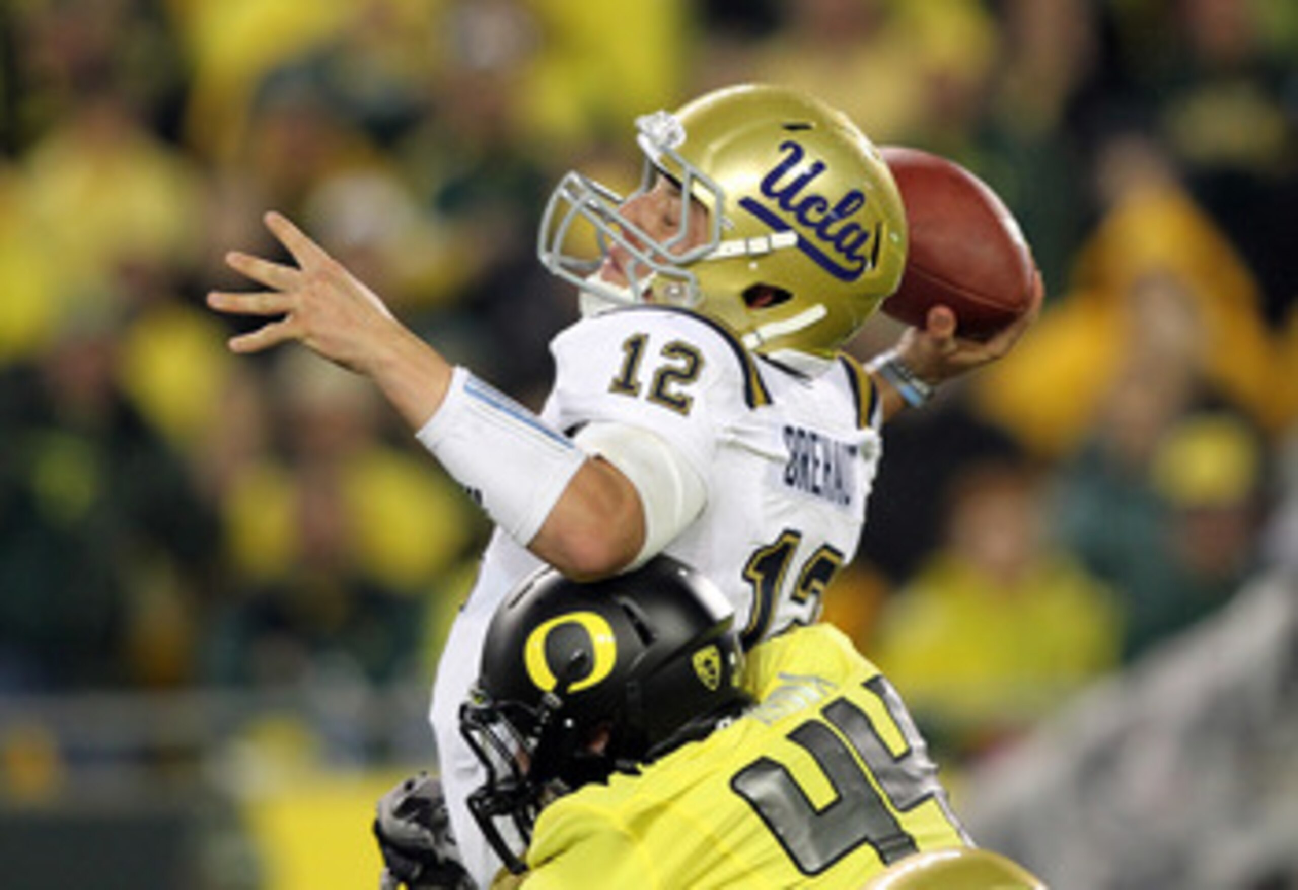 EUGENE, OR - OCTOBER 21: Richard Brehaut #12 of the UCLA Bruins is sacked by Brandon Hanna #44 of the Oregon Ducks on October 21, 2010 at the Autzen Stadium in Eugene, Oregon. (Photo by Jonathan Ferrey/Getty Images) EUGENE, OR - OCTOBER 21: Richard Brehaut #12 of the UCLA Bruins is sacked by Brandon Hanna #44 of the Oregon Ducks on October 21, 2010 at the Autzen Stadium in Eugene, Oregon. (Photo by Jonathan Ferrey/Getty Images)