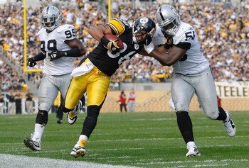 PITTSBURGH - NOVEMBER 21:  Hines Ward #86 of the Pittsburgh Steelers attempts to stiff arm Rolando McClain #55 of the Oakland Raiders after a catch during the game on November 21, 2010 at Heinz Field in Pittsburgh, Pennsylvania.  (Photo by Jared Wickerham