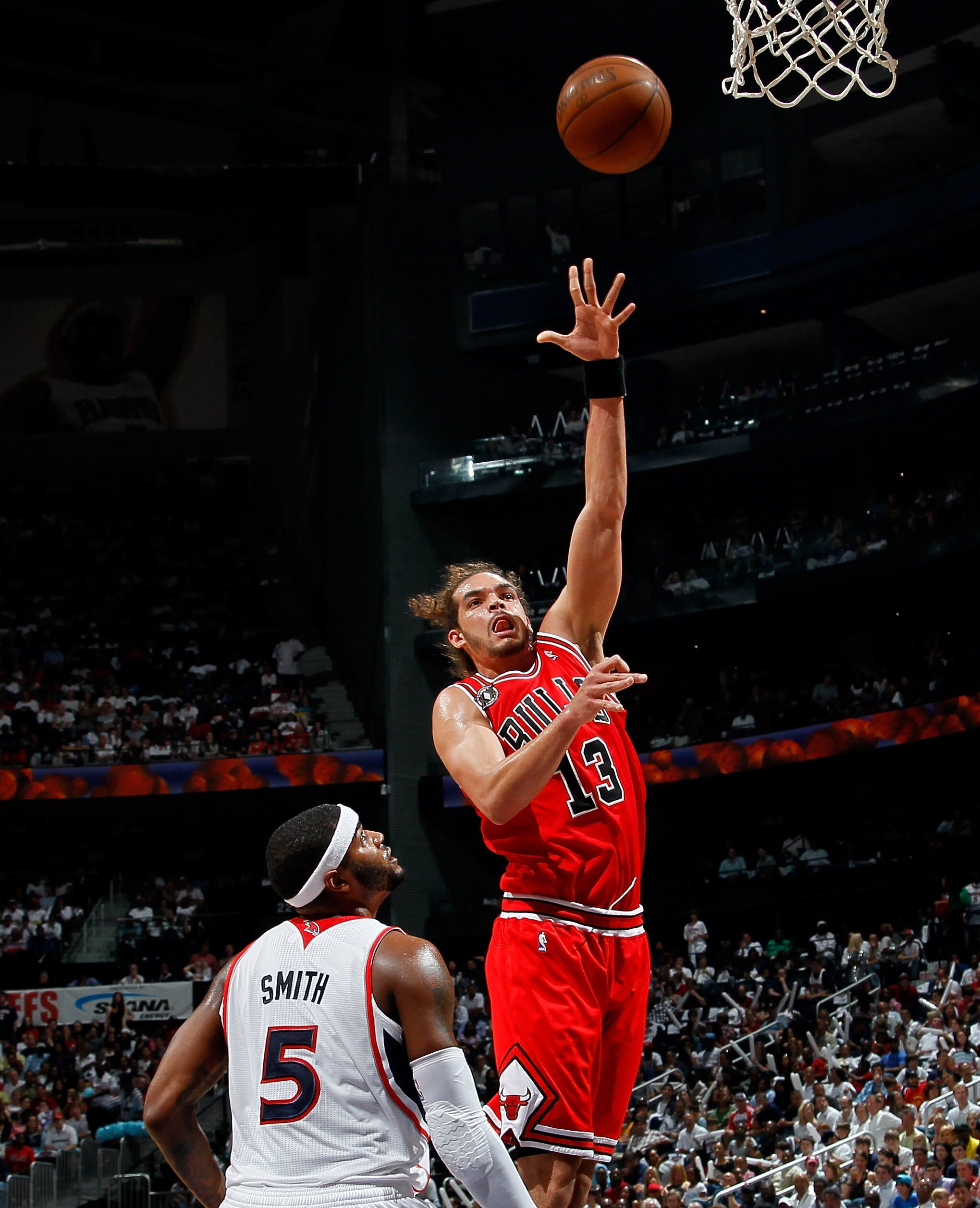 ATLANTA, GA - MAY 08:  Joakim Noah #13 of the Chicago Bulls shoots over Josh Smith #5 of the Atlanta Hawks in Game Four of the Eastern Conference Semifinals in the 2011 NBA Playoffs at Phillips Arena on May 8, 2011 in Atlanta, Georgia.  NOTE TO USER: User