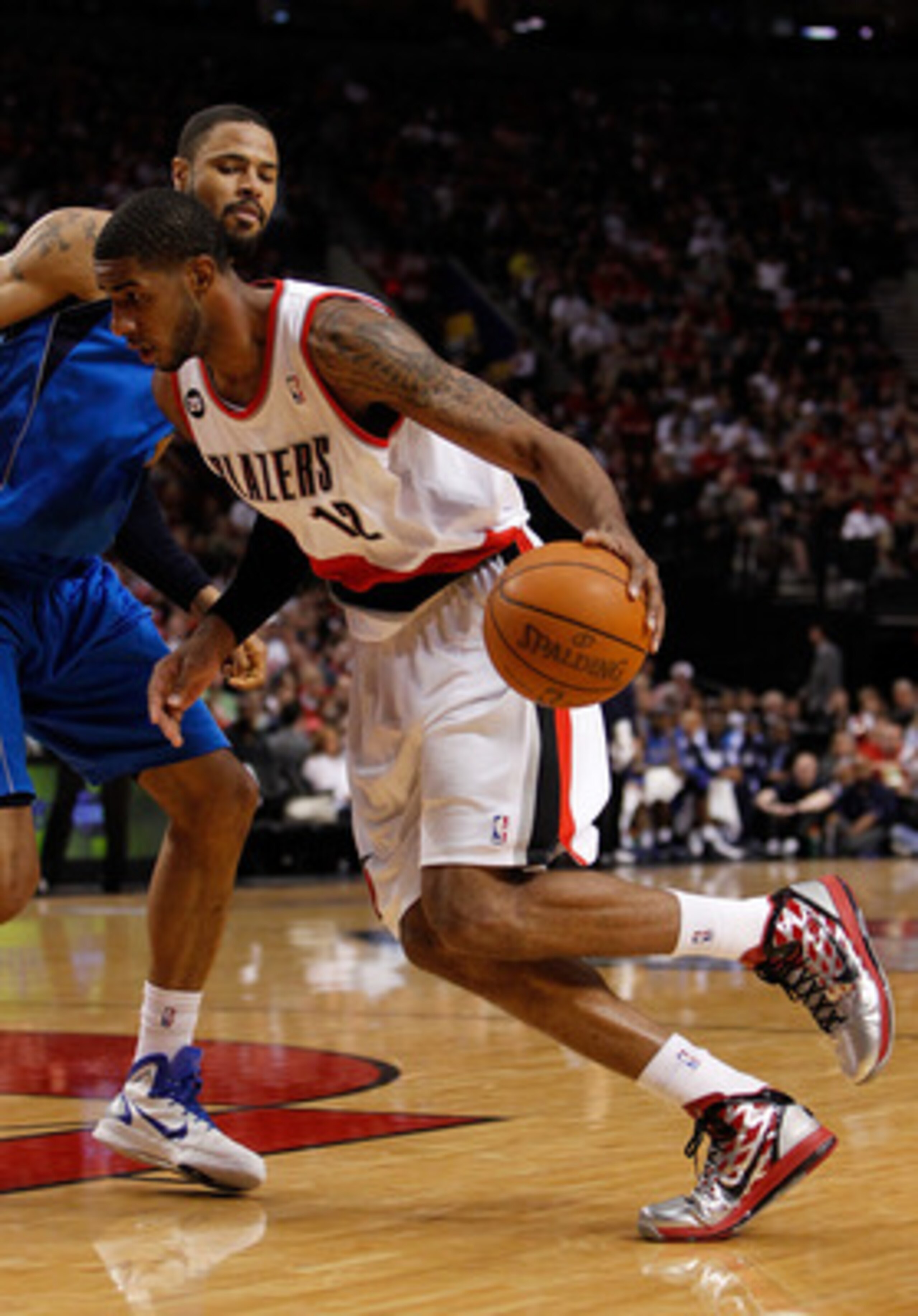 PORTLAND, OR - APRIL 23:  LaMarcus Aldrdige #12 of the Portland Trail Blazers drives against Tyson Chandler #6 of the Dallas Mavericks in Game Four of the Western Conference Quarterfinals in the 2011 NBA Playoffs on April 23, 2011 at the Rose Garden in Po