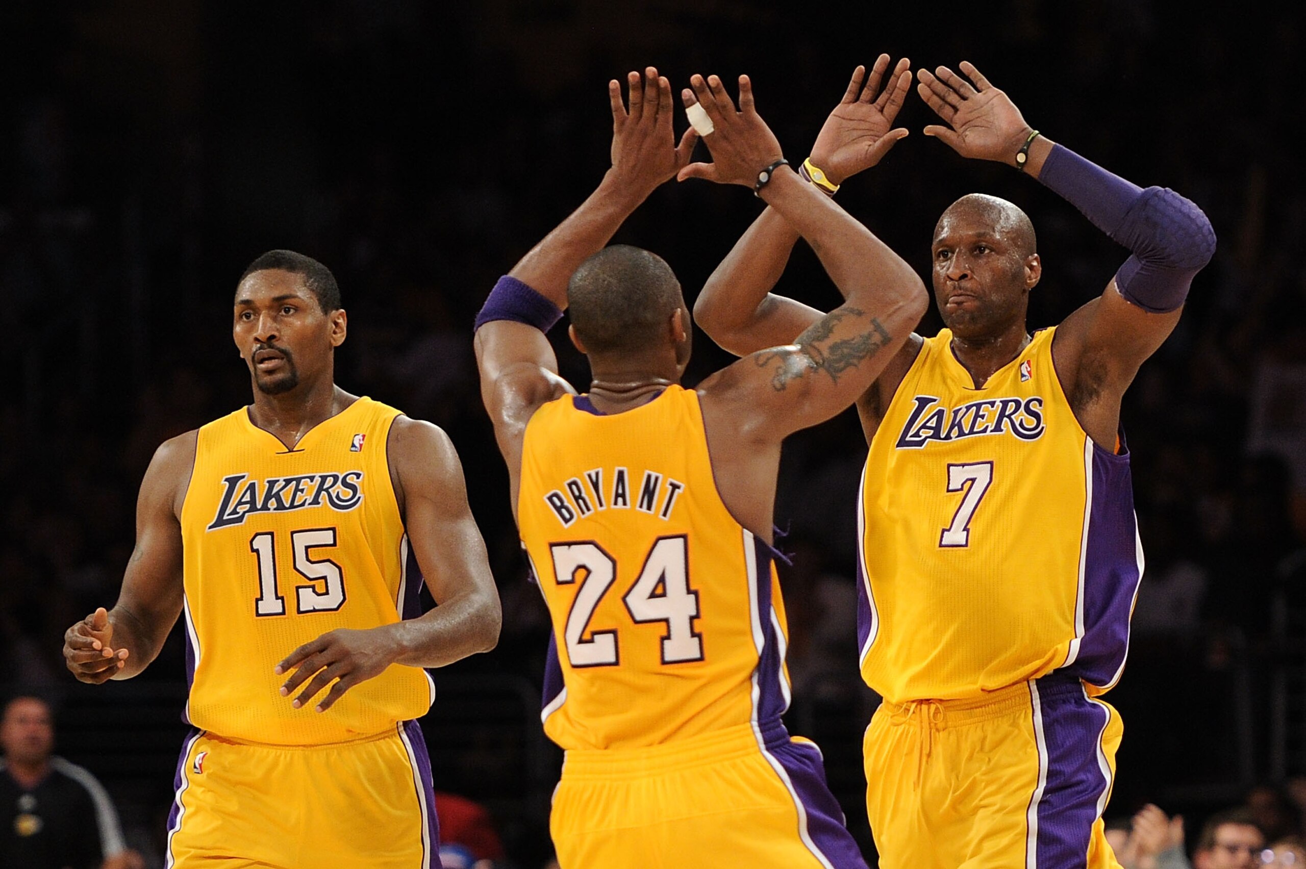 LOS ANGELES, CA - APRIL 20:  (R-L) Lamar Odom #7 and Kobe Bryant #24 of the Los Angeles Lakers celebrate on the court as they stand next to teammate Ron Artest #15 while taking on the New Orleans Hornets in Game Two of the Western Conference Quarterfinals