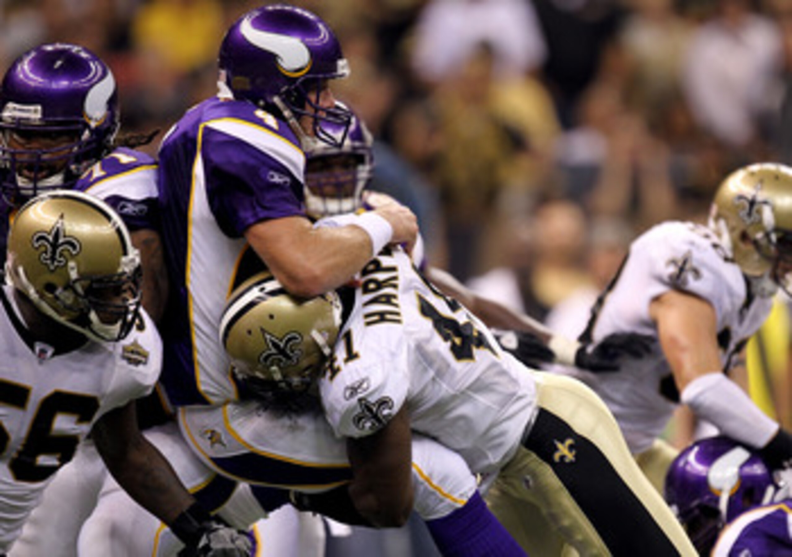 NEW ORLEANS - SEPTEMBER 09:  Quarterback Brett Favre #4 of the Minnesota Vikings takes a hard hit from Roman Harper #41 of the New Orleans Saints at Louisiana Superdome on September 9, 2010 in New Orleans, Louisiana.  (Photo by Ronald Martinez/Getty Image