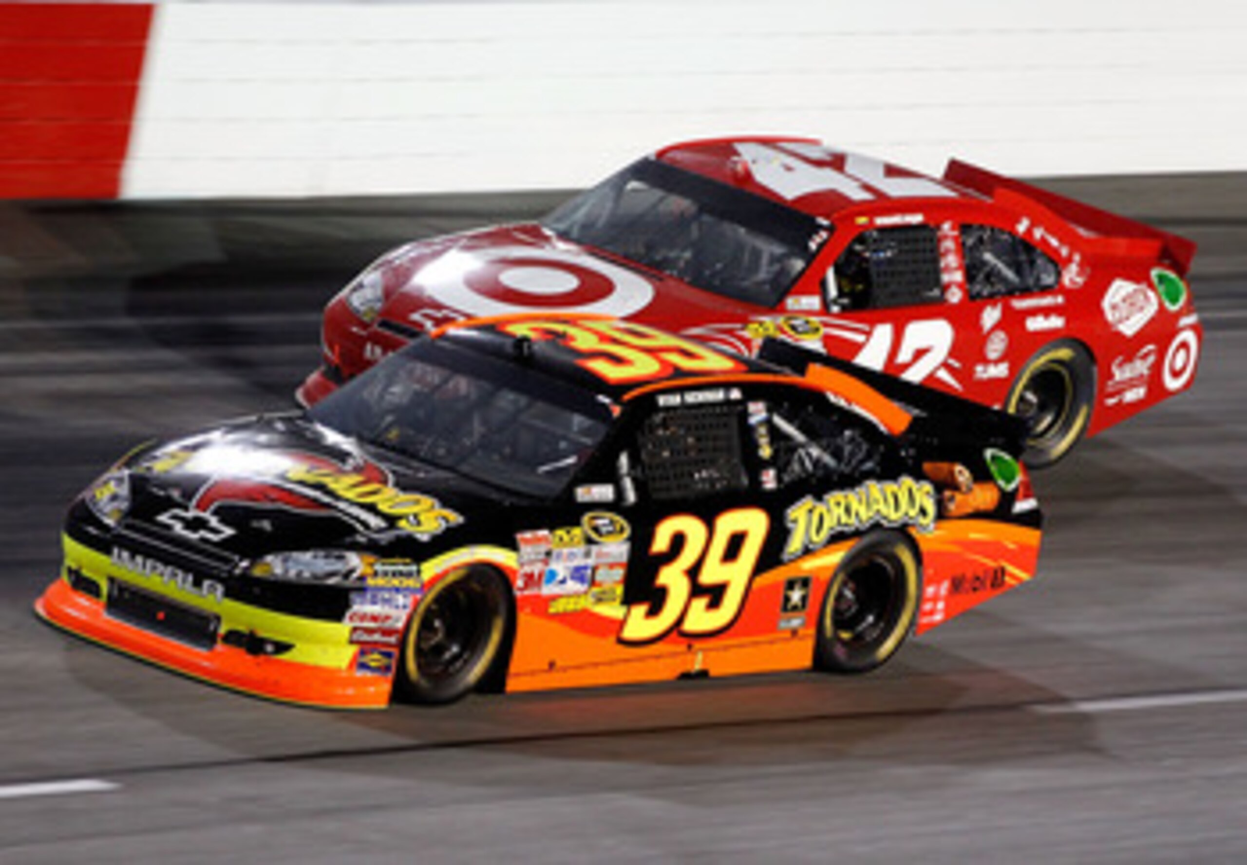 DARLINGTON, SC - MAY 07: Ryan Newman, driver of the #39 Tornados Chevrolet, races Juan Pablo Montoya, driver of the #42 Target Chevrolet, during the NASCAR Sprint Cup Series SHOWTIME Southern 500 at Darlington Raceway on May 7, 2011 in Darlington, South C