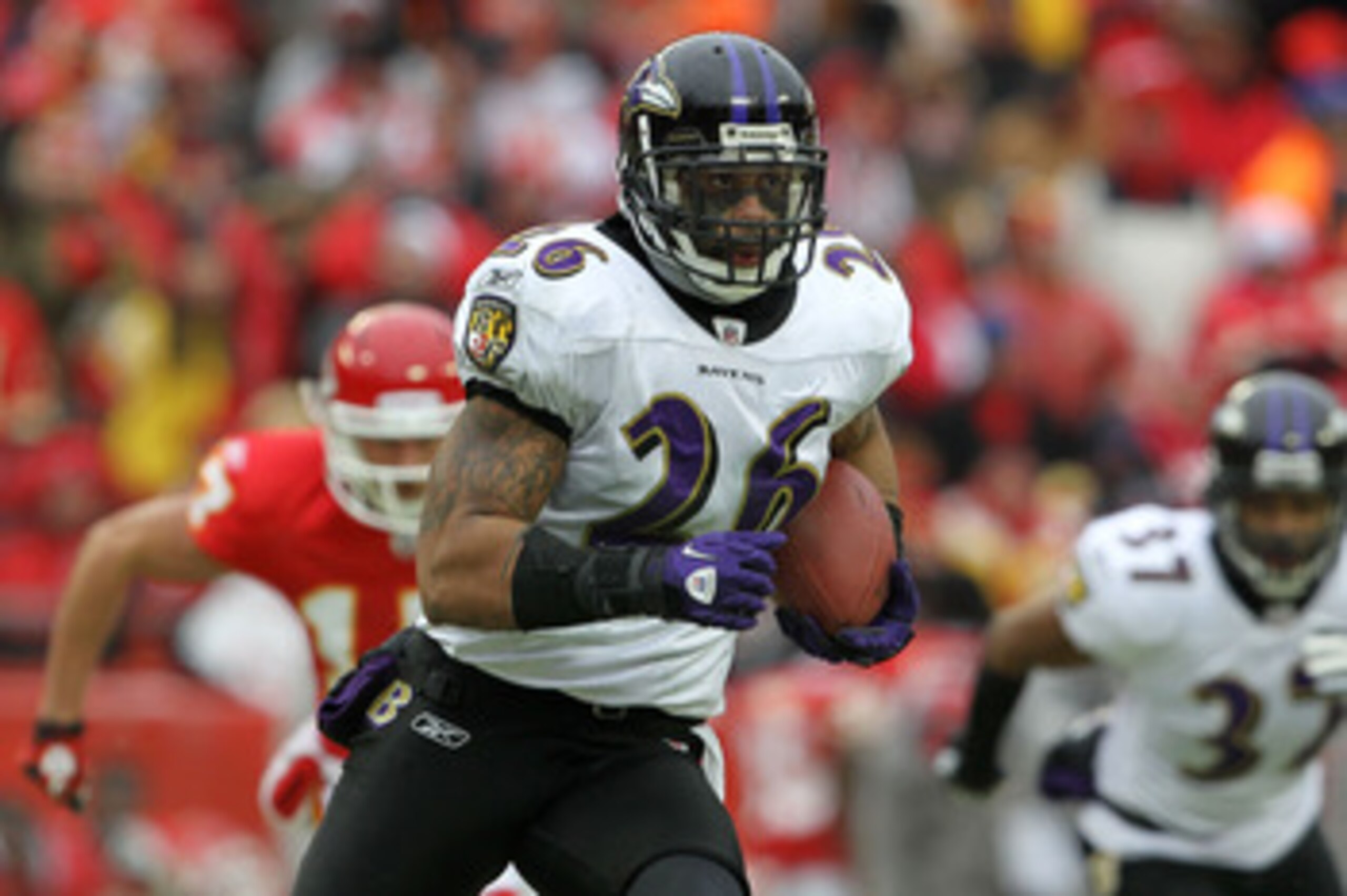 KANSAS CITY, MO - JANUARY 09:  Safety Dawan Landry #26 of the Baltimore Ravens runs back an interception of quarterback Matt Cassel #7 of the Kansas City Chiefs in the third quarter of their 2011 AFC wild card playoff game at Arrowhead Stadium on January 