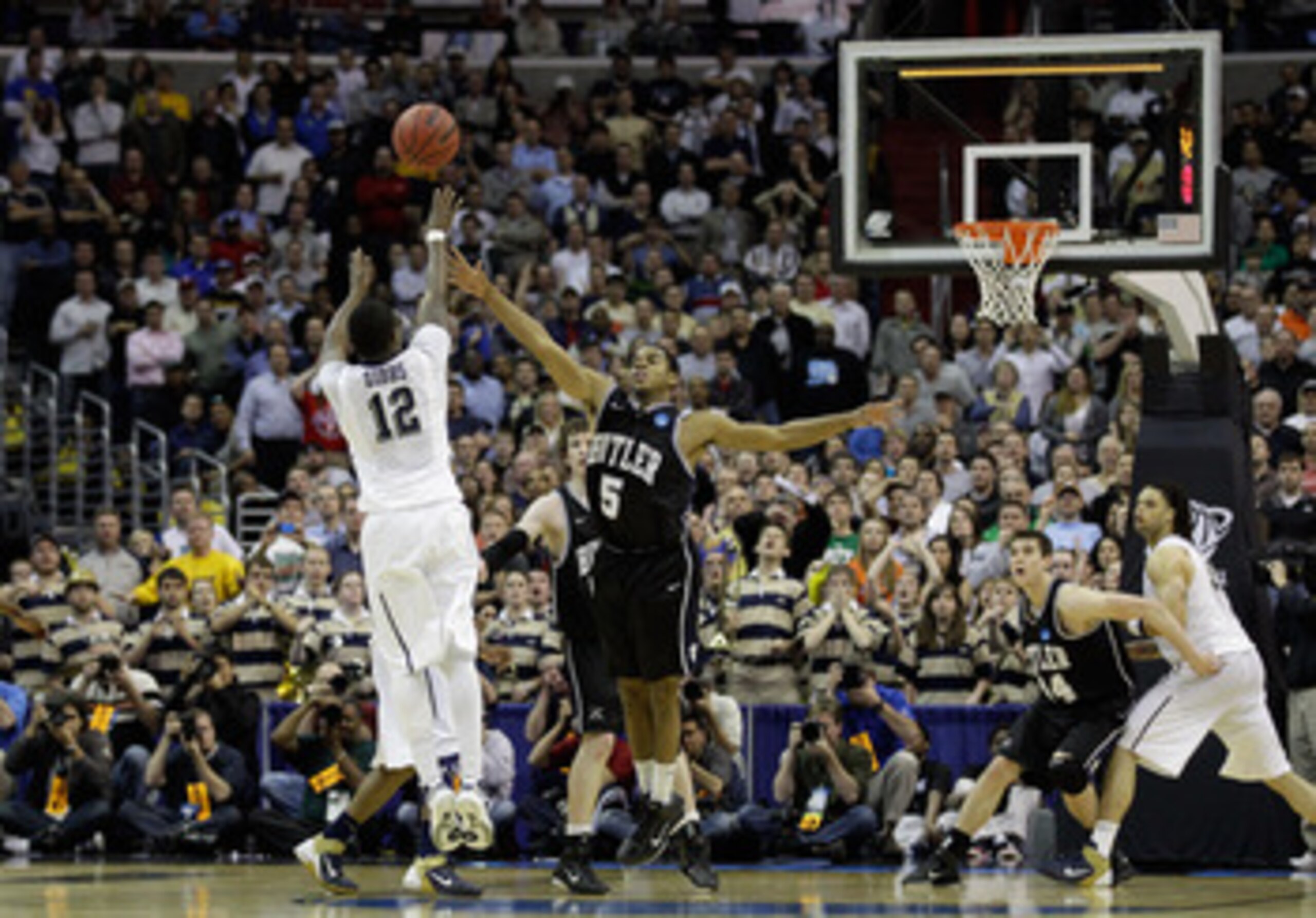 WASHINGTON - MARCH 19:  Ashton Gibbs #12 of the Pittsburgh Panthers puts up a shot over Ronald Nored #5 of the Butler Bulldogs during the third round of the 2011 NCAA men's basketball tournament at Verizon Center on March 19, 2011 in Washington, DC. Butle
