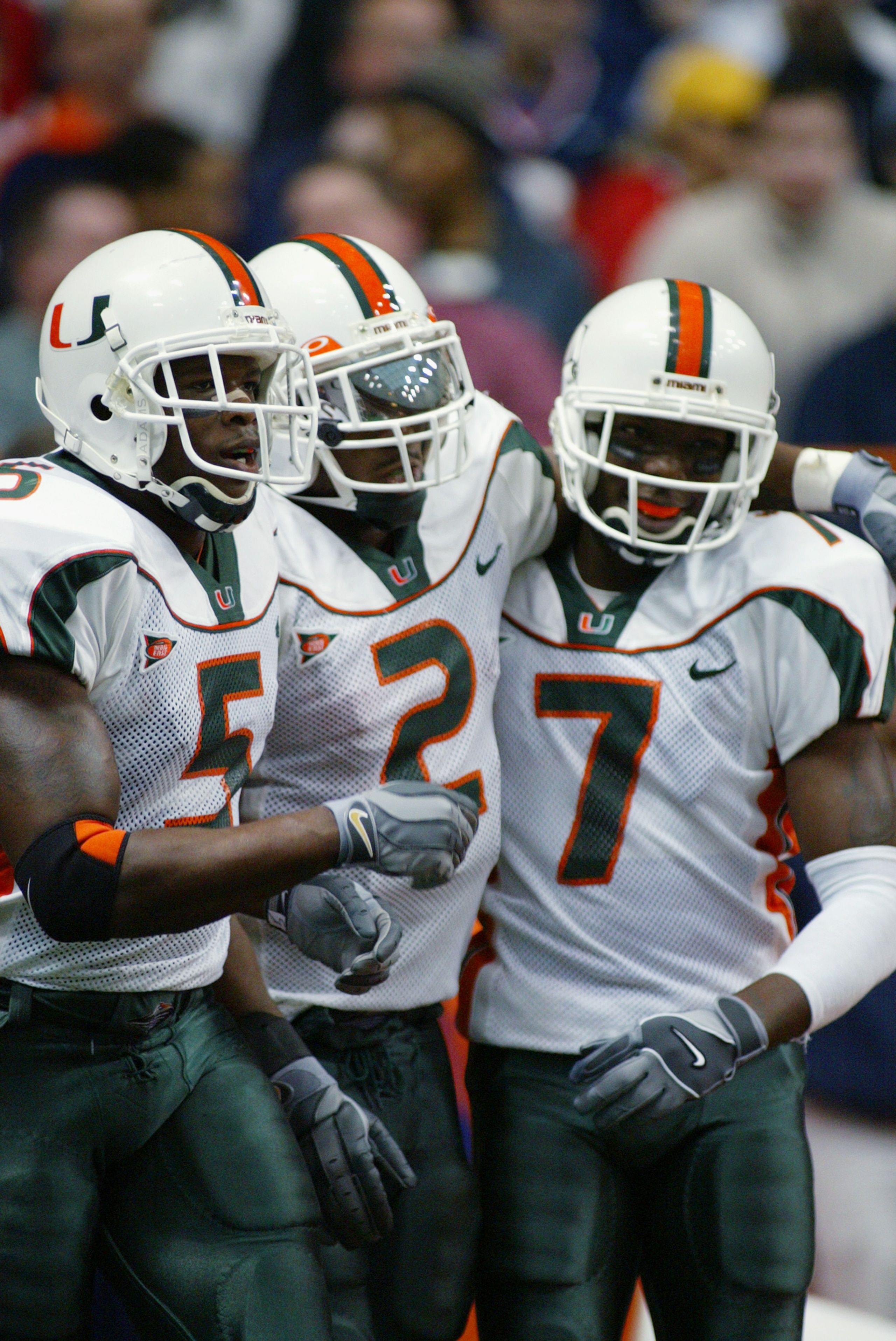 SYRACUSE, NY - NOVEMBER 30:  Running back Willis McGahee #2 of the University of Miami is congratulated by teammates Andre Johnson #5, and Ethenic Sands #7 after rushing for a touchdown during the game against Syracuse University at the Carrier Dome on No